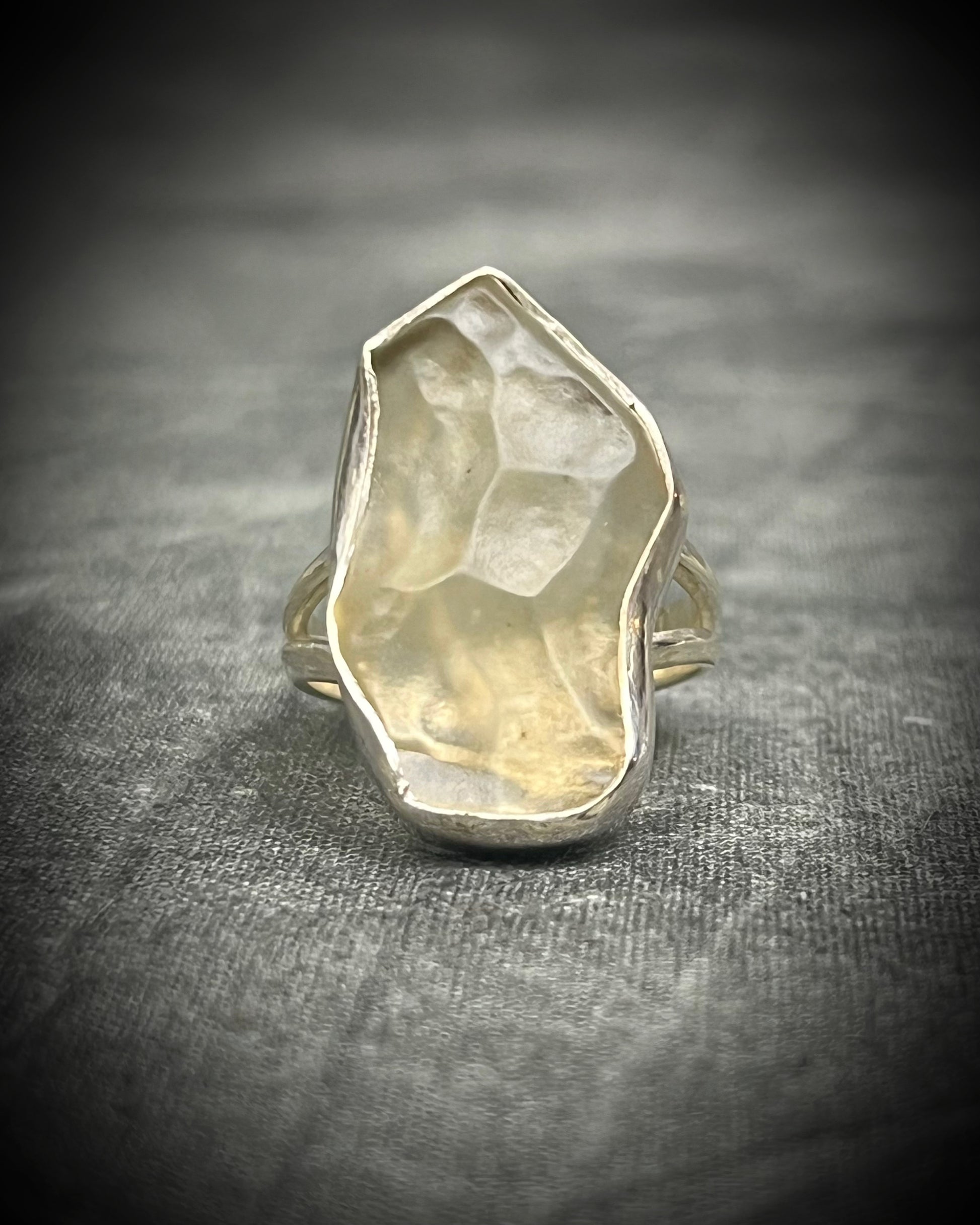 Genuine Libyan Desert Glass sterling silver ring featuring ancient impact glass with luminous golden tones. One of a kind by Become Spellbound, Baltimore Magazine Best of Baltimore 2026 Jewelry winner.