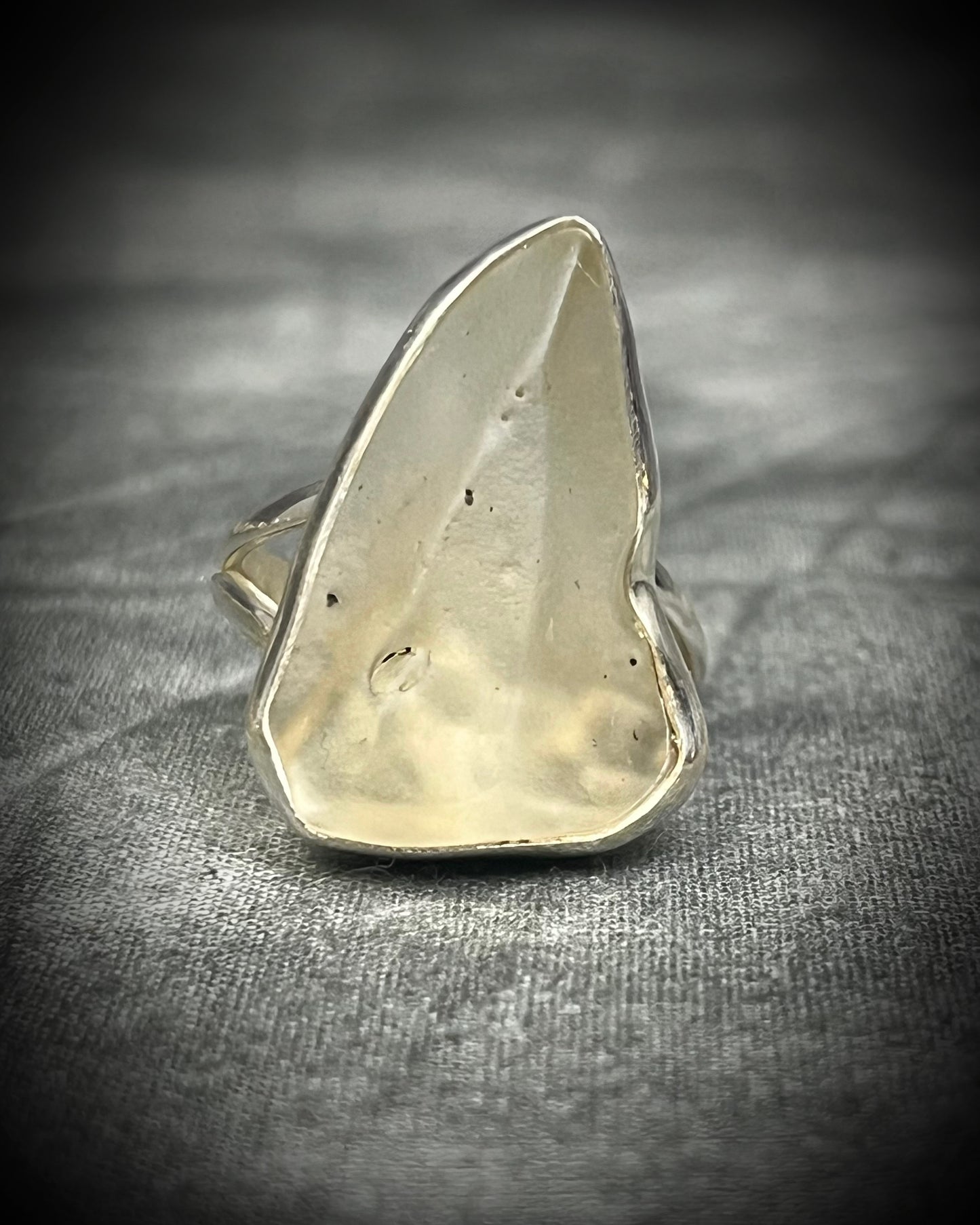 Genuine Libyan Desert Glass sterling silver ring featuring ancient impact glass with luminous golden tones. One of a kind by Become Spellbound, Baltimore Magazine Best of Baltimore 2026 Jewelry winner.