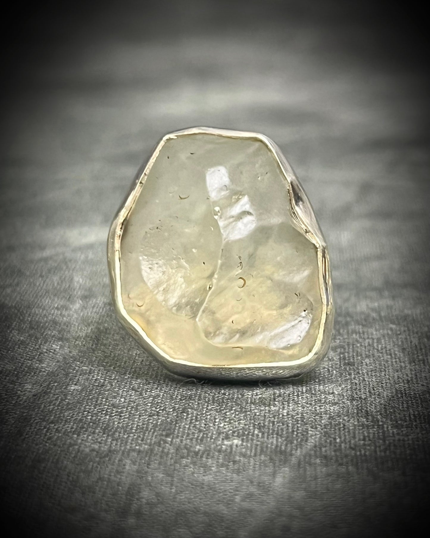 Genuine Libyan Desert Glass sterling silver ring featuring ancient impact glass with luminous golden tones. One of a kind by Become Spellbound, Baltimore Magazine Best of Baltimore 2026 Jewelry winner.