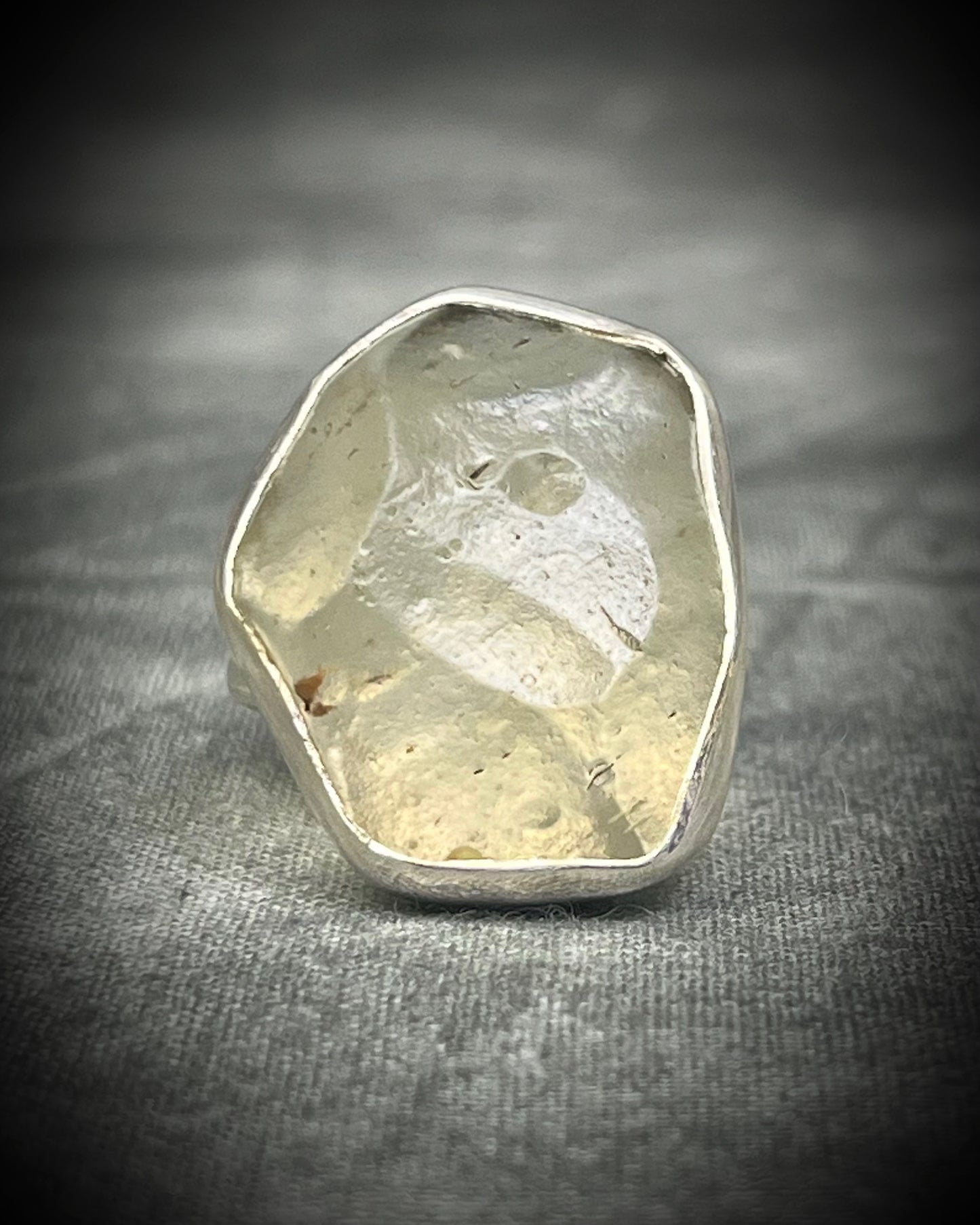 Genuine Libyan Desert Glass sterling silver ring featuring ancient impact glass with luminous golden tones. One of a kind by Become Spellbound, Baltimore Magazine Best of Baltimore 2026 Jewelry winner.