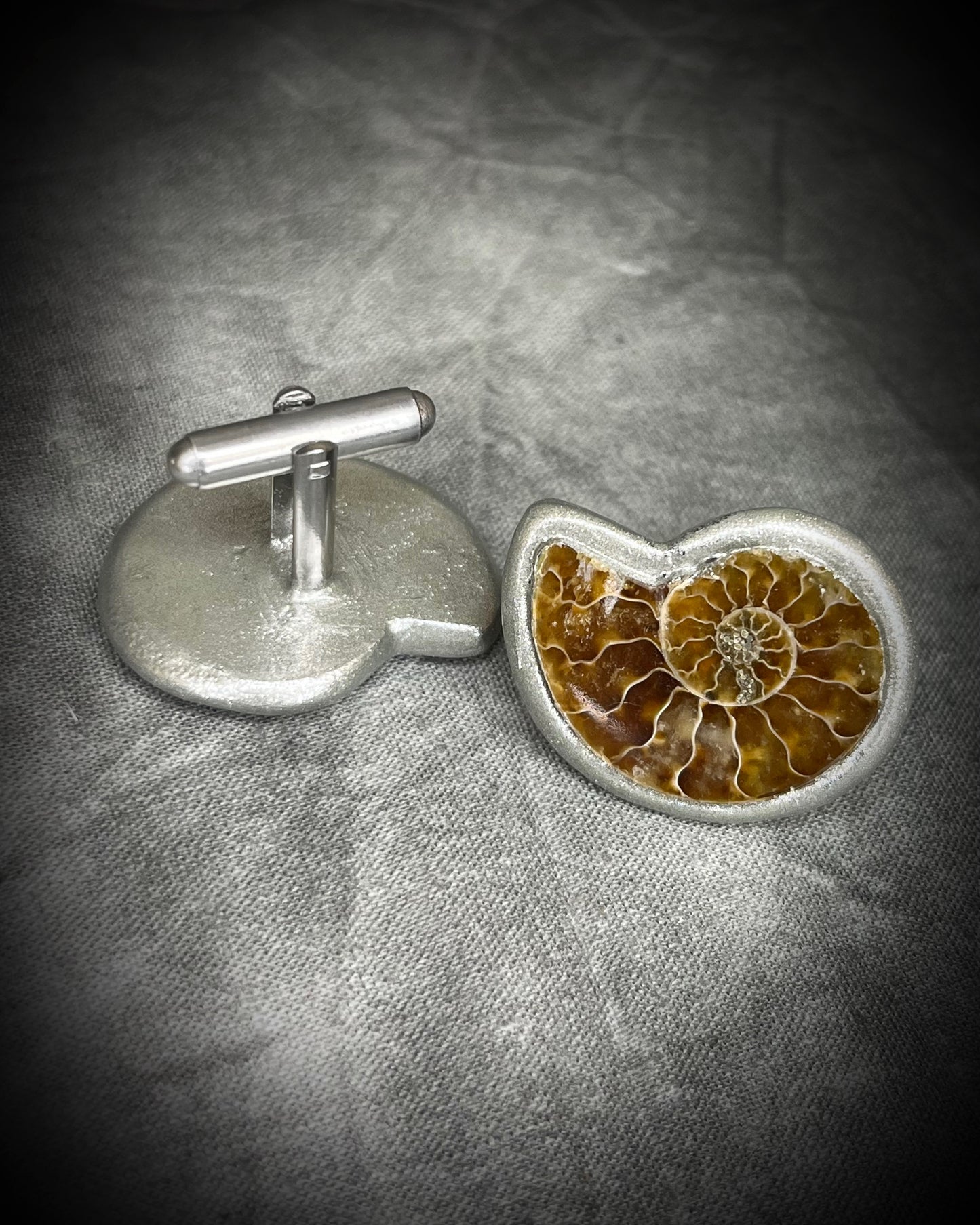Genuine ammonite fossil cufflinks with silver finish and stainless steel cufflink bases, featuring natural spiral fossils. One-of-a-kind mens accessories by Become Spellbound.