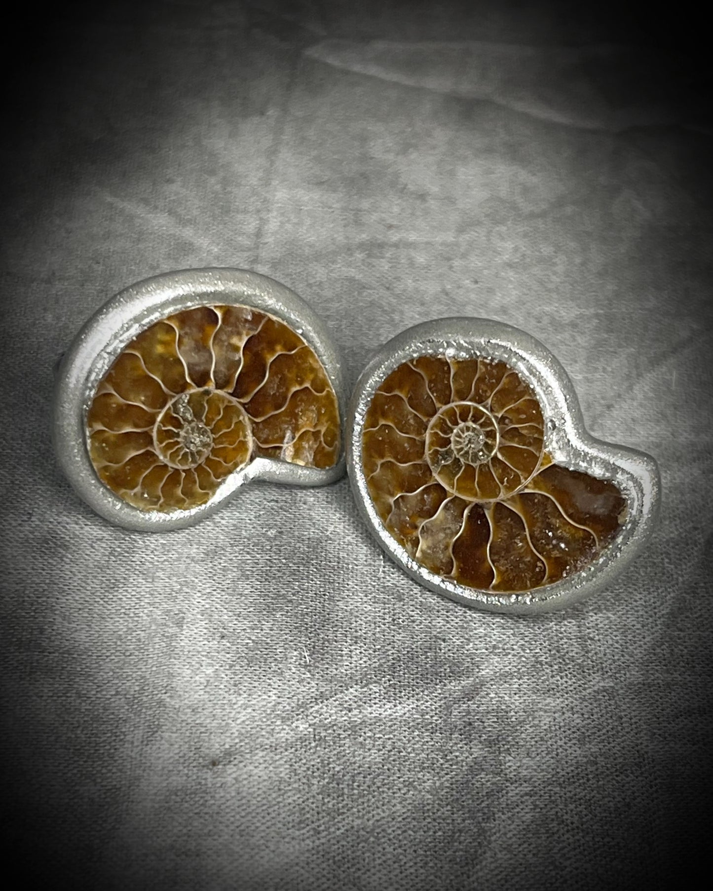 Genuine ammonite fossil cufflinks with silver finish and stainless steel cufflink bases, featuring natural spiral fossils. One-of-a-kind mens accessories by Become Spellbound.