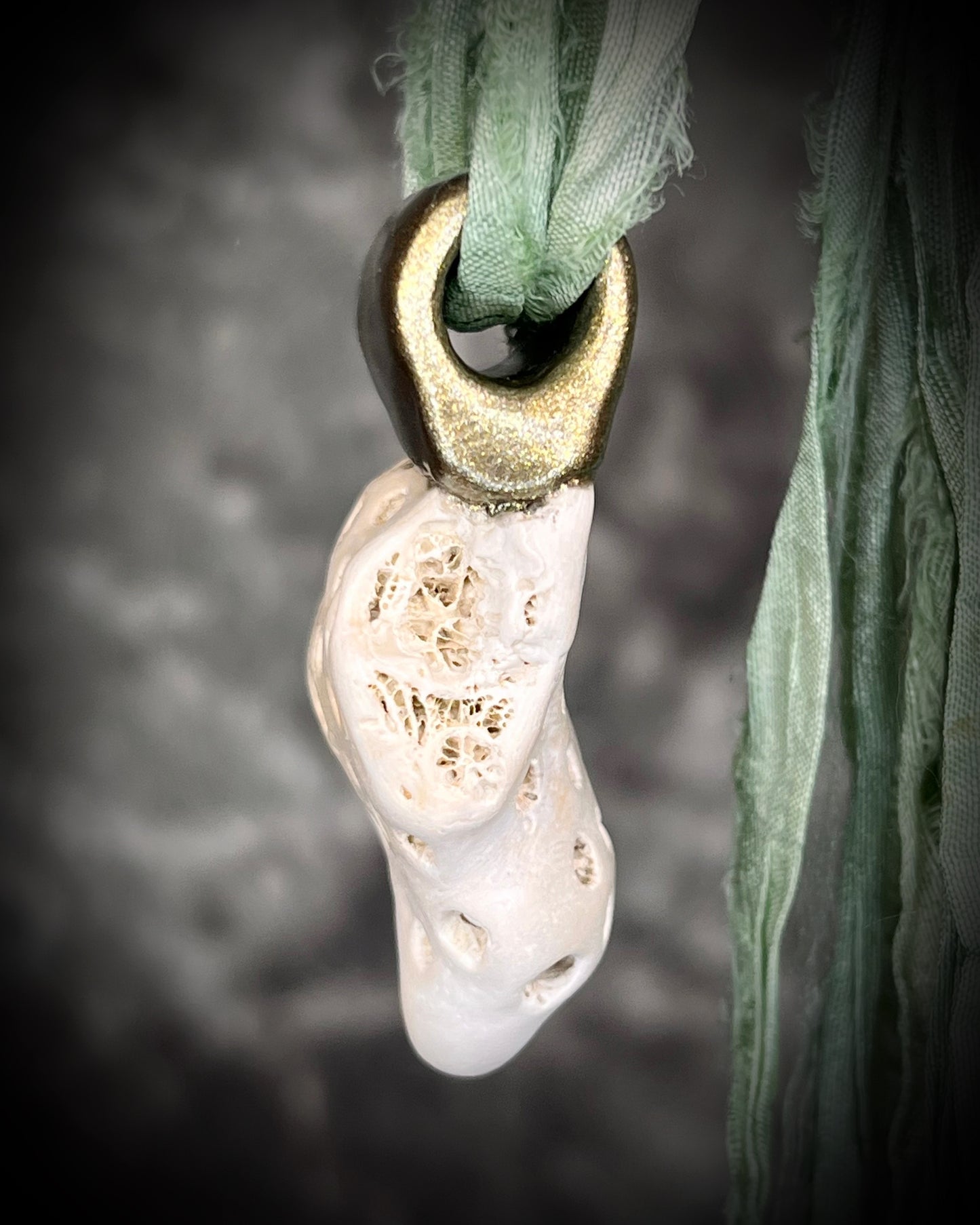 Genuine fossil coral set in a gold setting and hung from sea green recycled silks as a beachy oceanic summer jewelry look. Necklace handmade in Baltimore with coral from Calvert Cliffs.