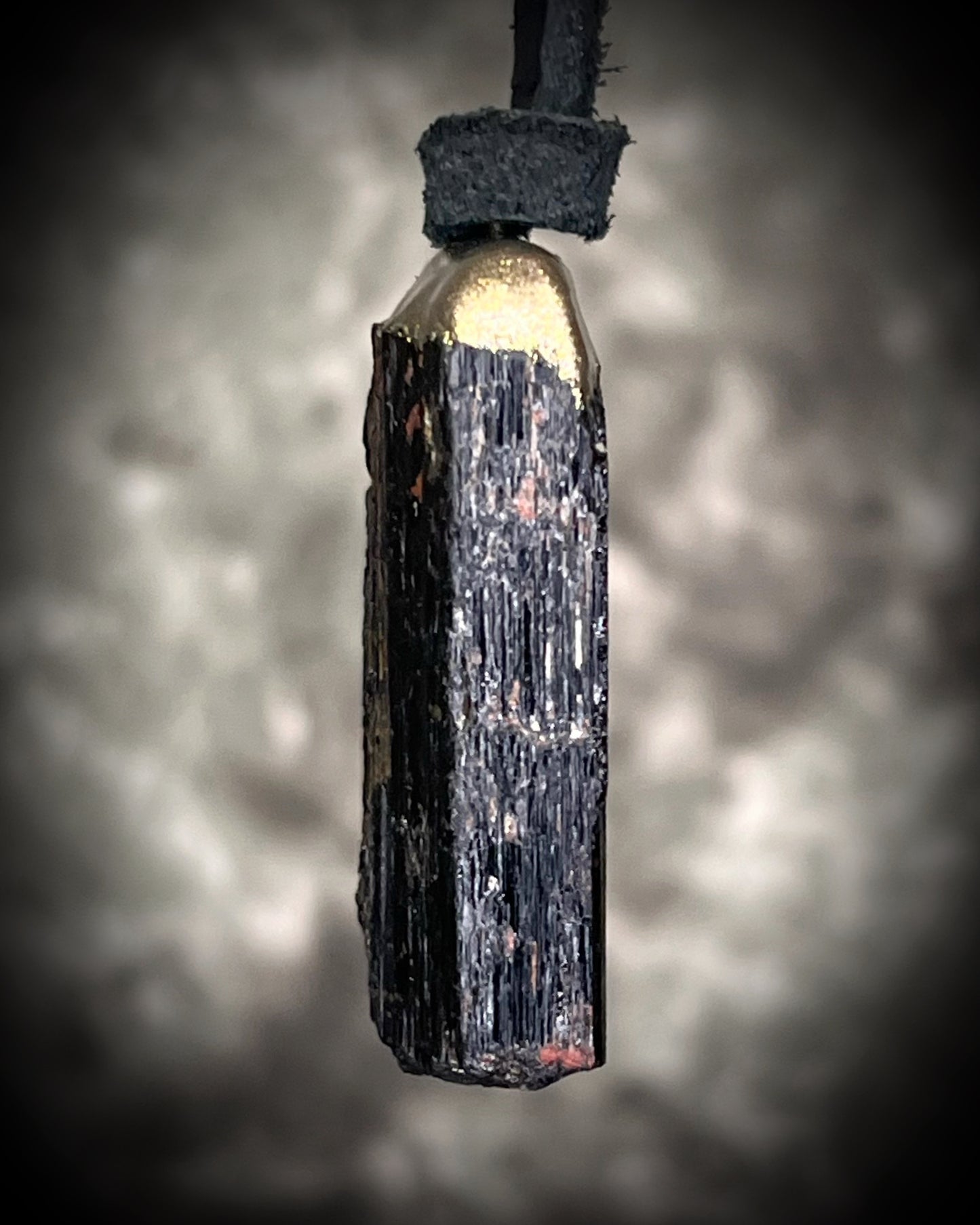 Gold finish, square shaped raw stone Black tourmaline grounding and protection pendant hung from black leather for an earthy adornment. Open back to touch skin and ground you. 