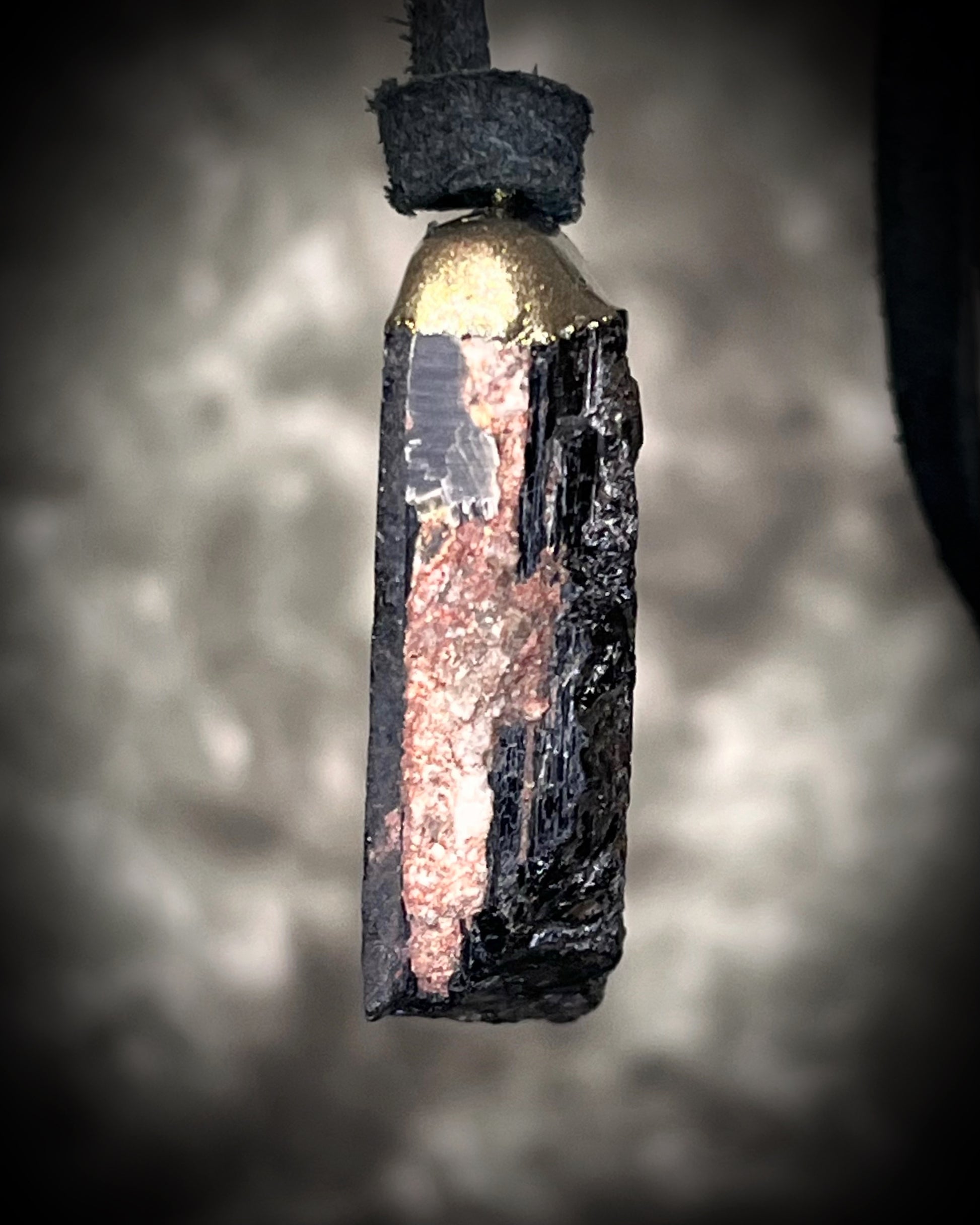 Gold finish, square shaped raw stone Black tourmaline grounding and protection pendant hung from black leather for an earthy adornment. Open back to touch skin and ground you. 