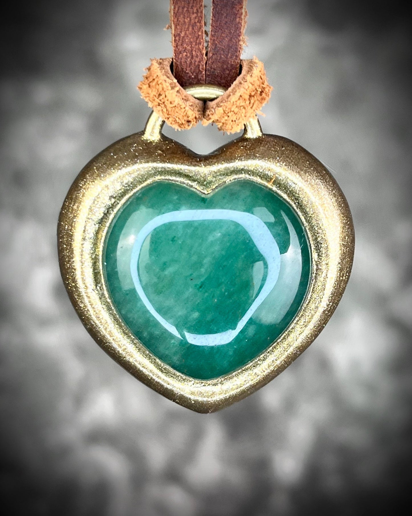 Green Aventurine crystal heart necklace on brown leather. Jewelry for luck, abundance, valentine's day and everyday magic!