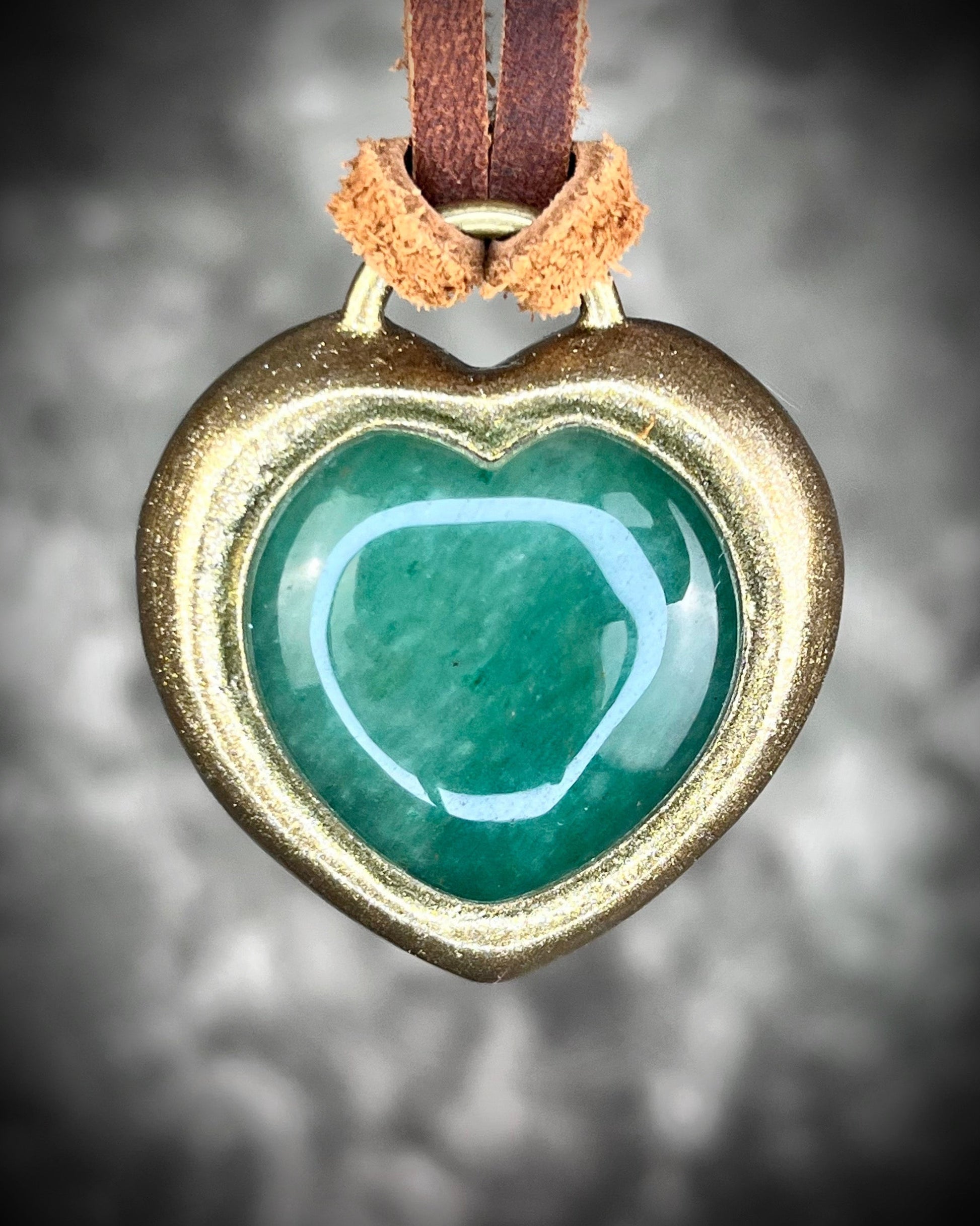 Green Aventurine crystal heart necklace on brown leather. Jewelry for luck, abundance, valentine's day and everyday magic!