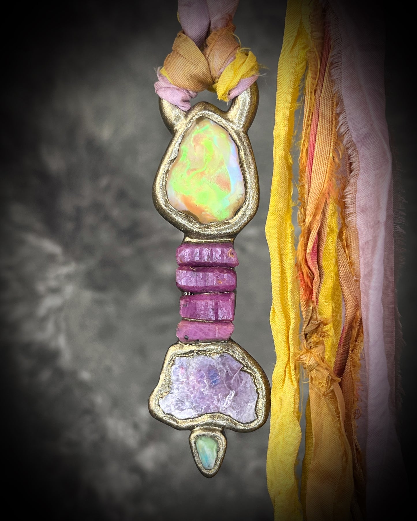 Handcrafted Libyan Desert Glass, Ruby, Lepidolite and Green Tourmaline Museum grade talisman pendant hung from recycled silks in a gold sculptural finish. 