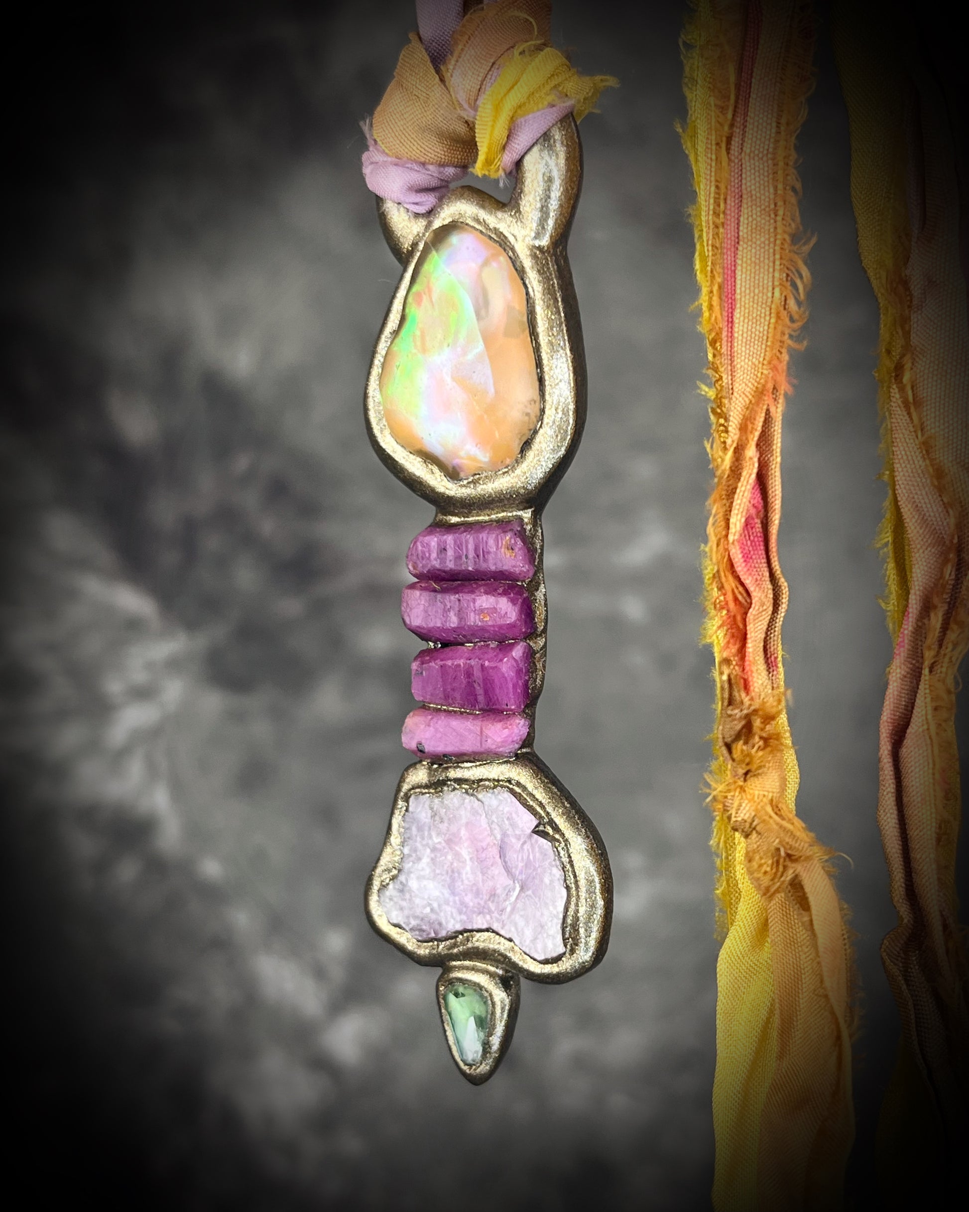 Handcrafted Libyan Desert Glass, Ruby, Lepidolite and Green Tourmaline Museum grade talisman pendant hung from recycled silks in a gold sculptural finish. 