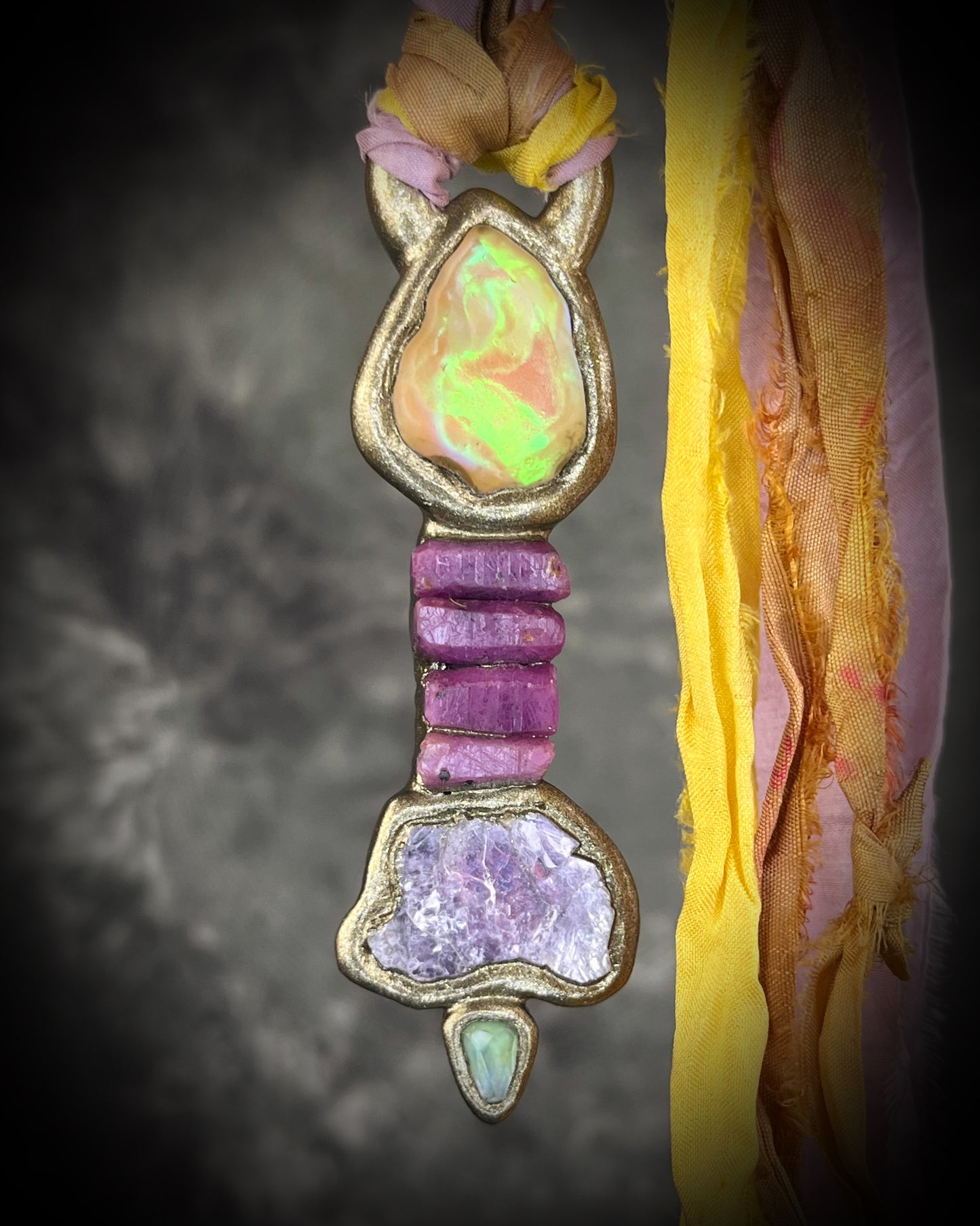 Handcrafted Libyan Desert Glass, Ruby, Lepidolite and Green Tourmaline Museum grade talisman pendant hung from recycled silks in a gold sculptural finish. 