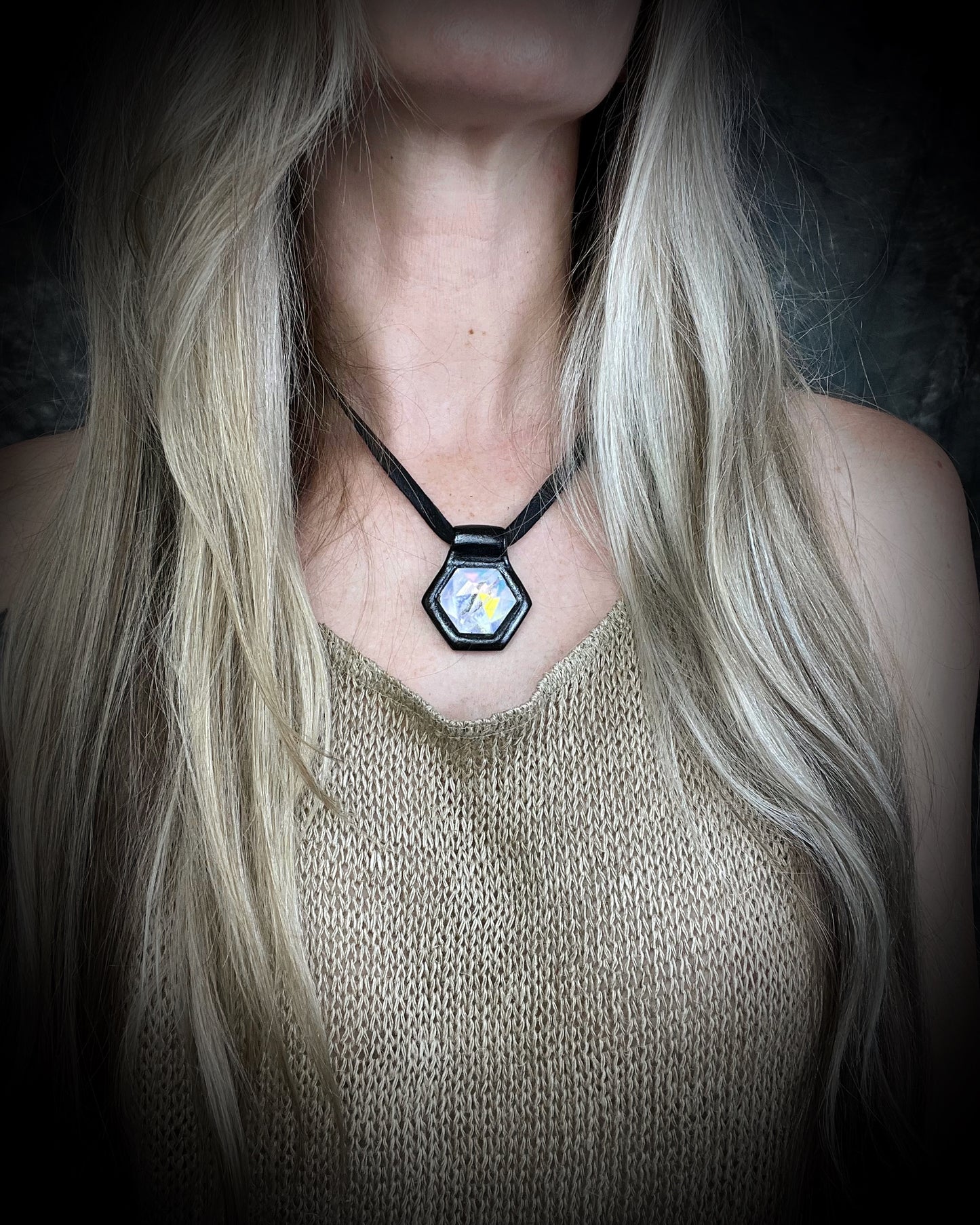 Handcrafted opalescent quartz crystal talisman with iridescent shimmer, black framed pendant on leather cord, mystical statement necklace for seekers and dreamers.