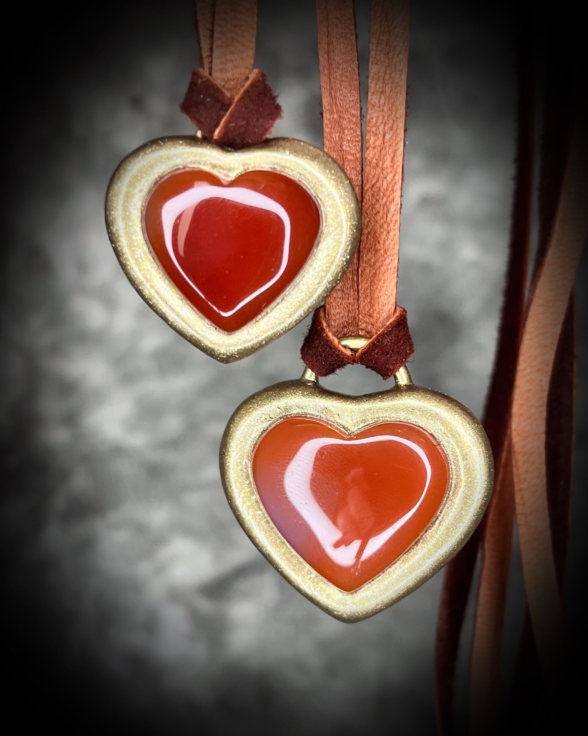Handmade Carnelian crystal heart necklace on earthy brown leather cord, bold fall jewelry with warm orange gemstone, grounding and energizing boho style talisman.