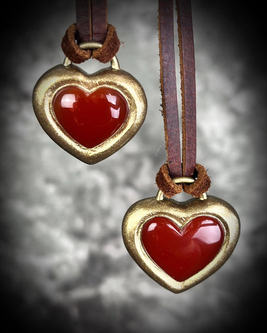 Handmade Carnelian crystal heart necklace on earthy brown leather cord, bold fall jewelry with warm orange gemstone, grounding and energizing boho style talisman.