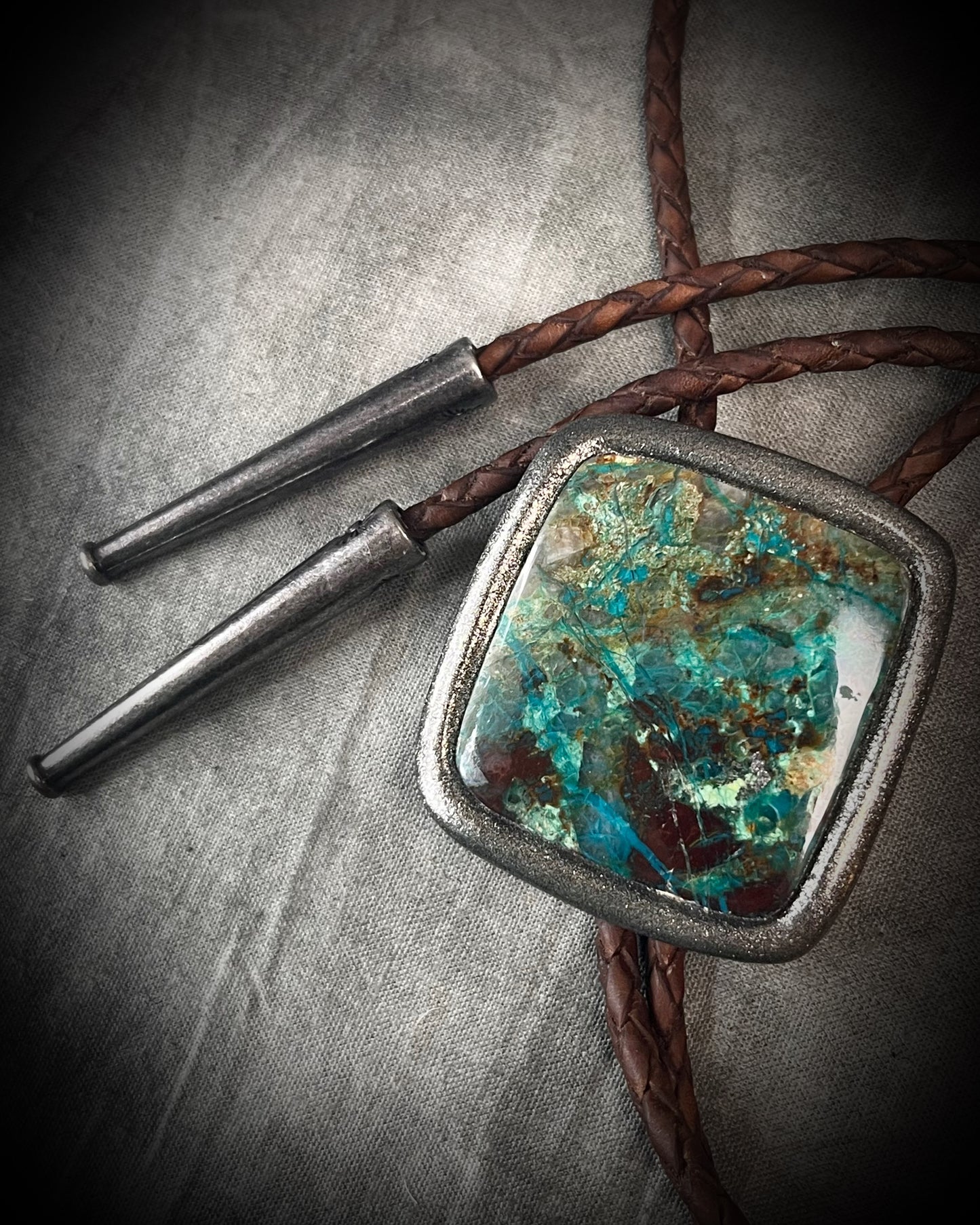 Handmade Chrysocolla Bolo Tie in Silver Finish with Silver Tips on Brown Braided Leather. Artisan modern bolo tie gift for him. 
