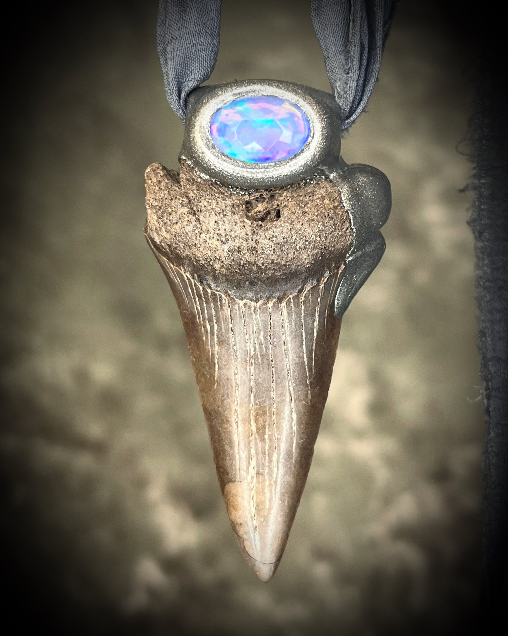 Handmade Ethereal and Powerful Mako shark tooth and opal fossil pendant on grey recycled silk. 