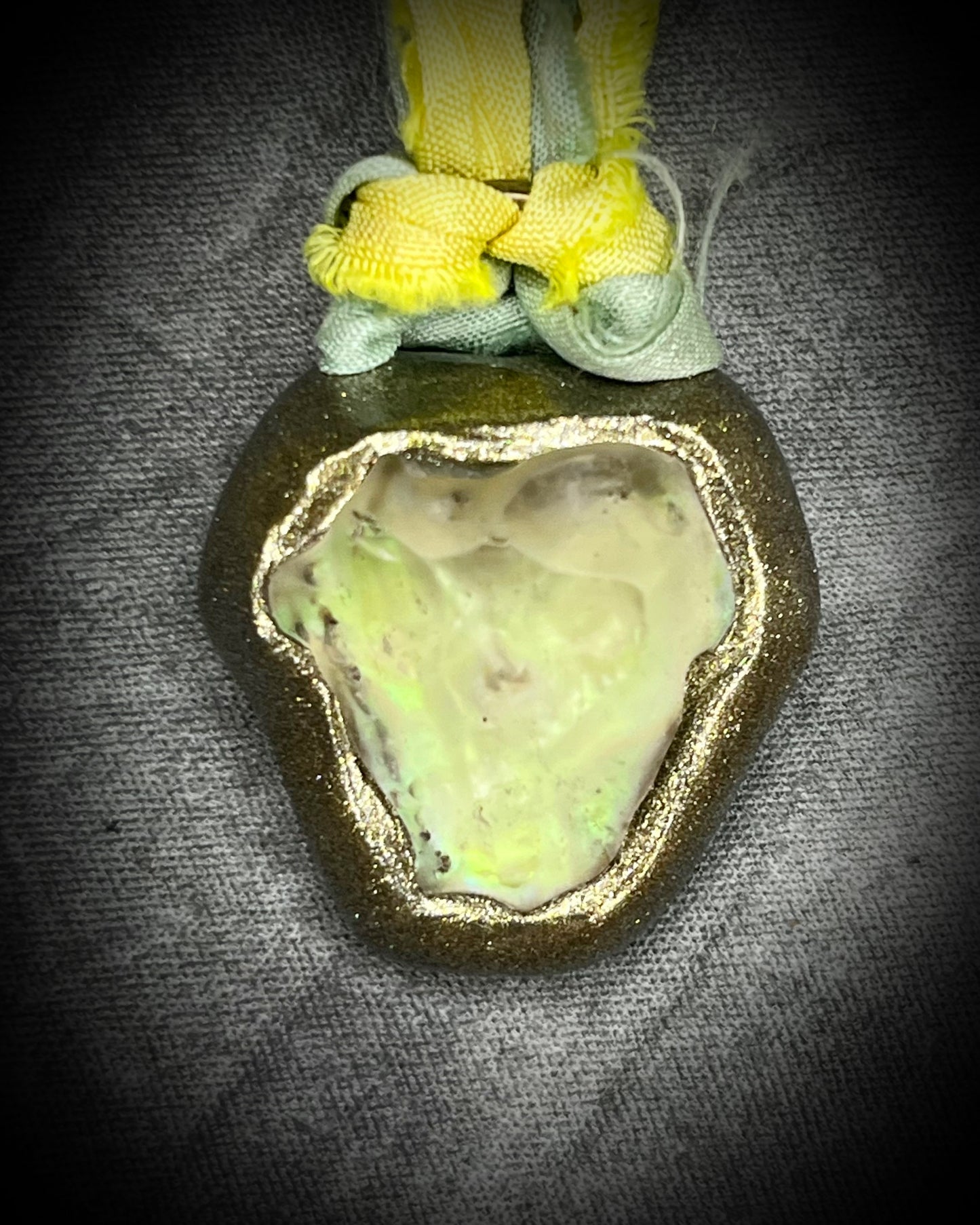 Handmade Libyan Desert Glass necklaces with luminous shifting flashes of green, gold, peach, and rose on sea green and yellow recycled silk by Become Spellbound.