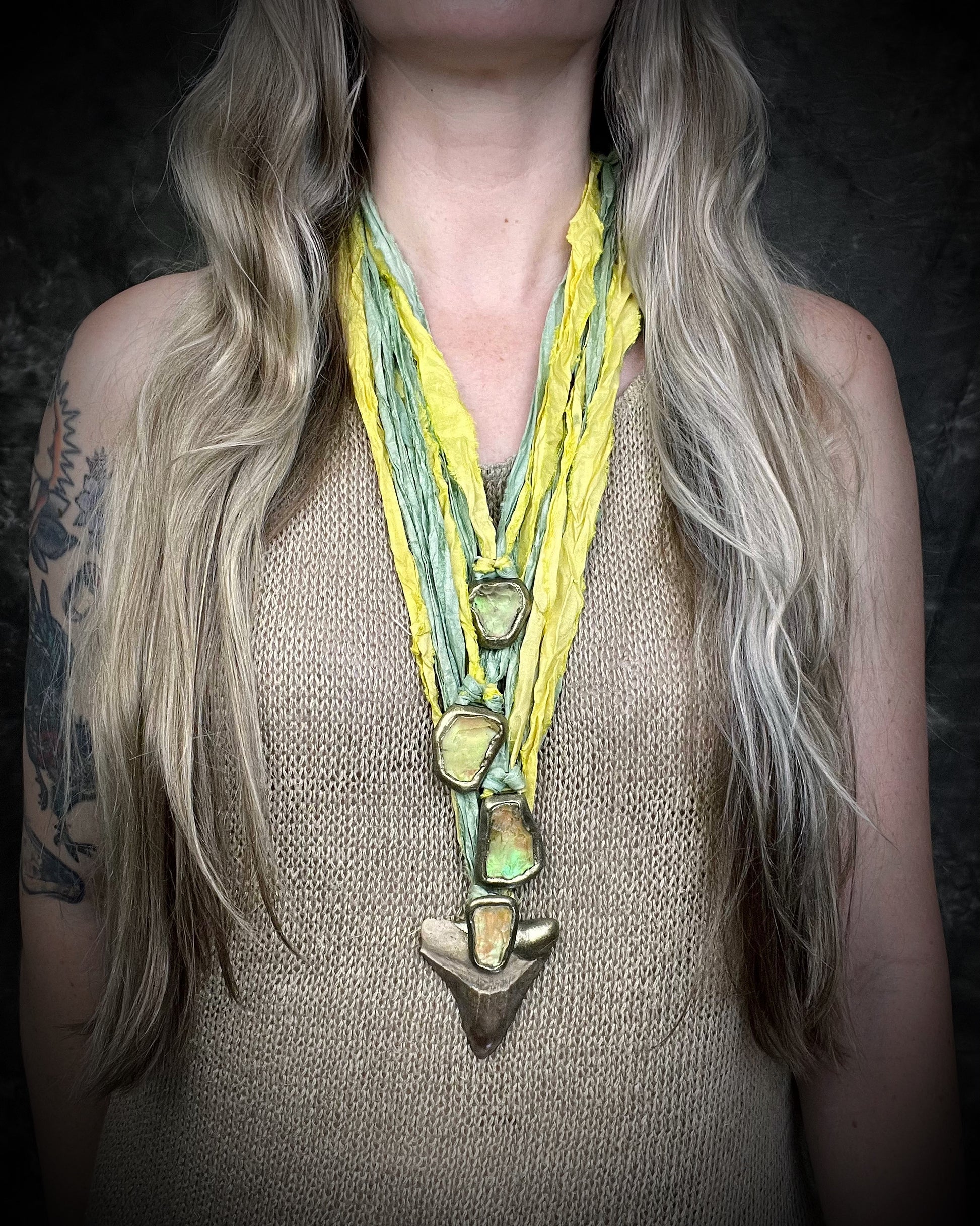 Handmade Libyan Desert Glass necklaces with luminous shifting flashes of green, gold, peach, and rose on sea green and yellow recycled silk by Become Spellbound.
