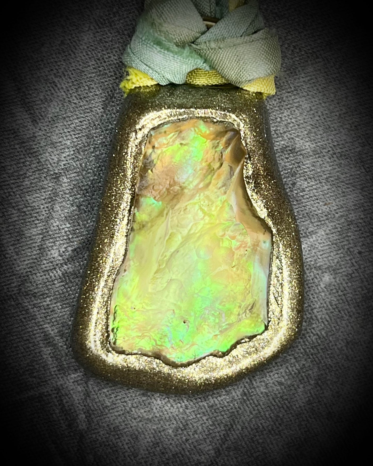 Handmade Libyan Desert Glass necklaces with luminous shifting flashes of green, gold, peach, and rose on sea green and yellow recycled silk by Become Spellbound.