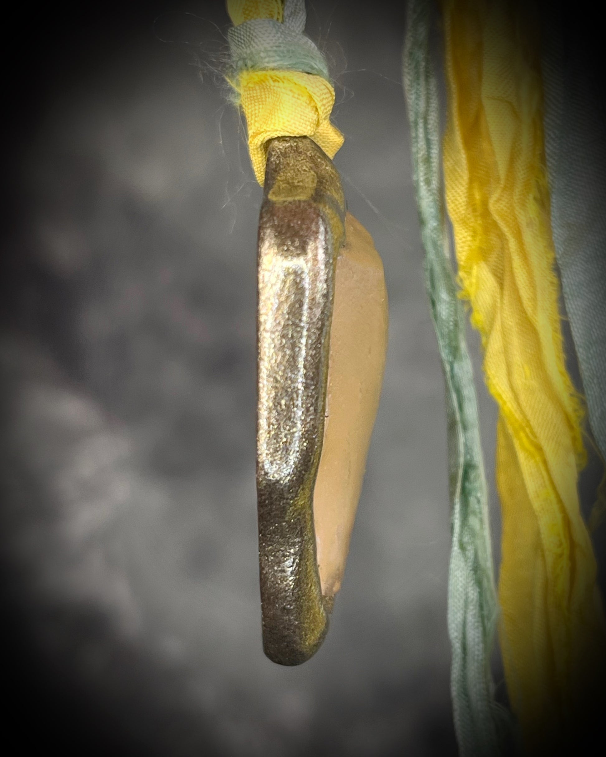 Handmade Libyan Desert Glass necklaces with luminous shifting flashes of green, gold, peach, and rose on sea green and yellow recycled silk by Become Spellbound.