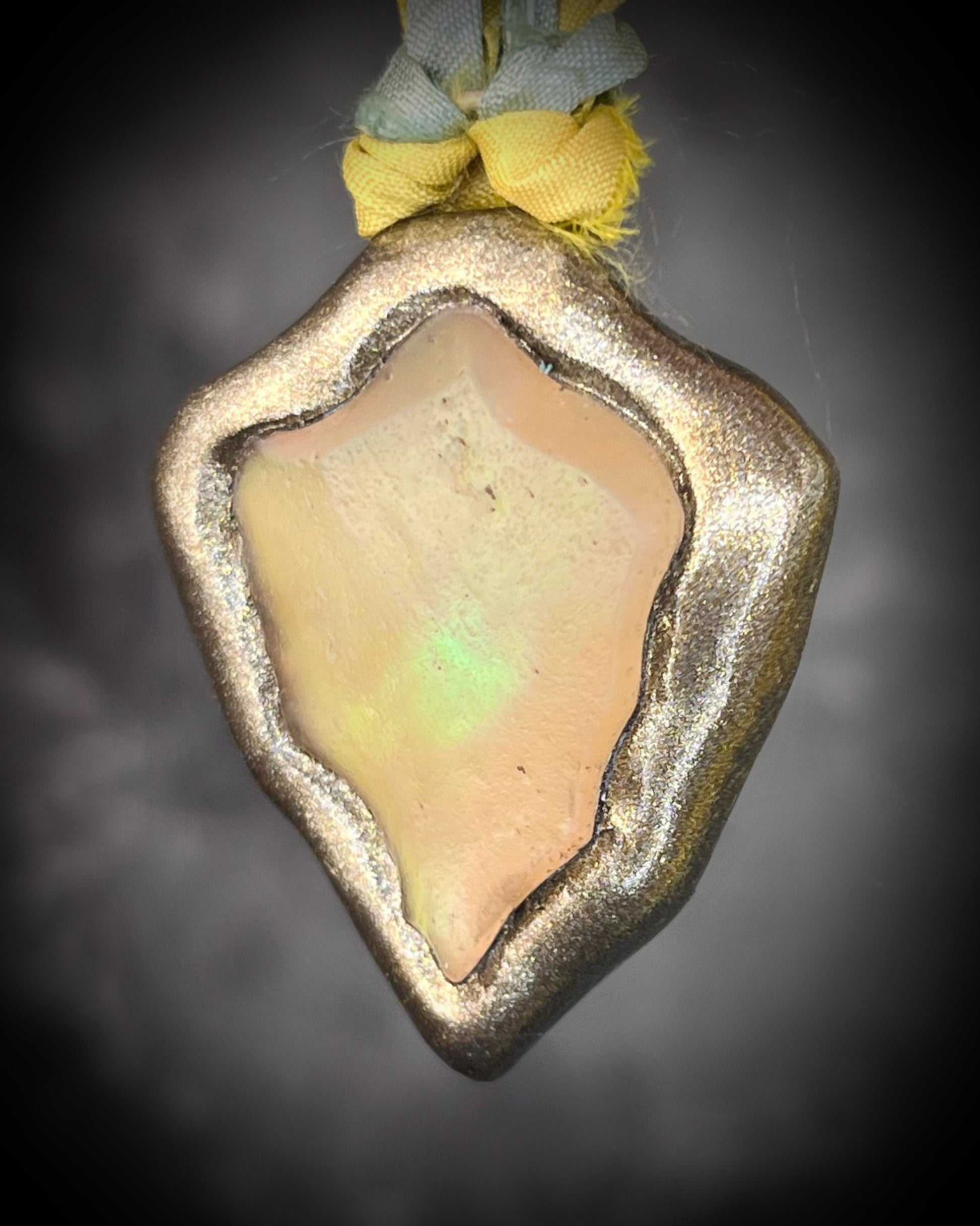 Handmade Libyan Desert Glass necklaces with luminous shifting flashes of green, gold, peach, and rose on sea green and yellow recycled silk by Become Spellbound.