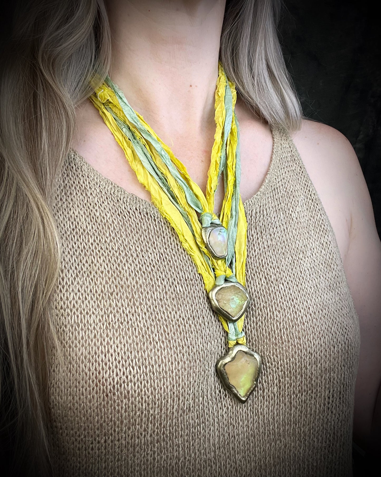 Handmade Libyan Desert Glass necklaces with luminous shifting flashes of green, gold, peach, and rose on sea green and yellow recycled silk by Become Spellbound.