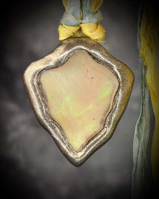 Handmade Libyan Desert Glass necklaces with luminous shifting flashes of green, gold, peach, and rose on sea green and yellow recycled silk by Become Spellbound.