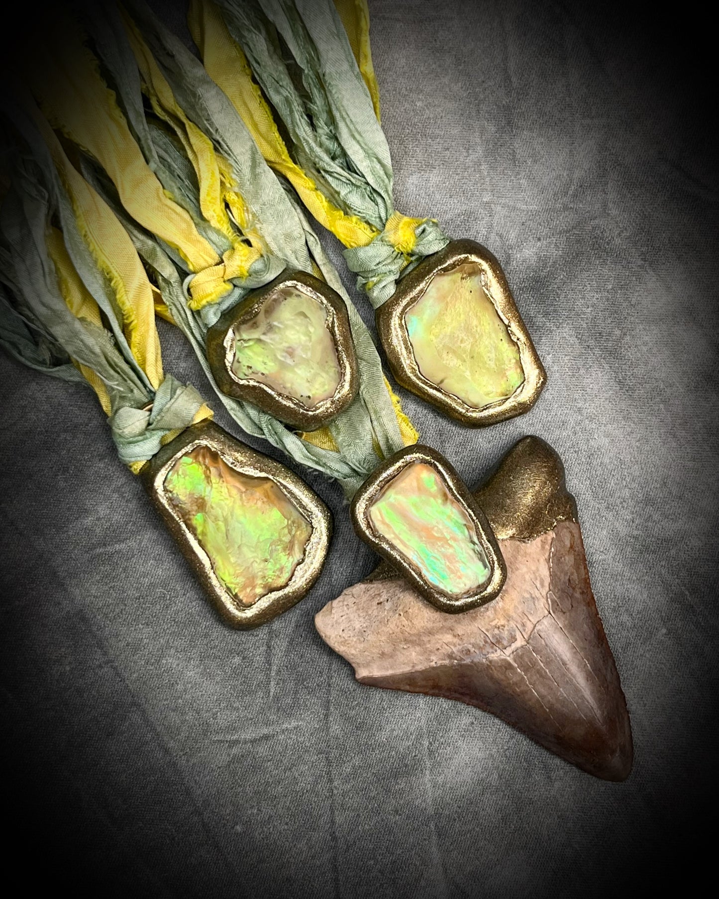Handmade Libyan Desert Glass necklaces with luminous shifting flashes of green, gold, peach, and rose on sea green and yellow recycled silk by Become Spellbound.