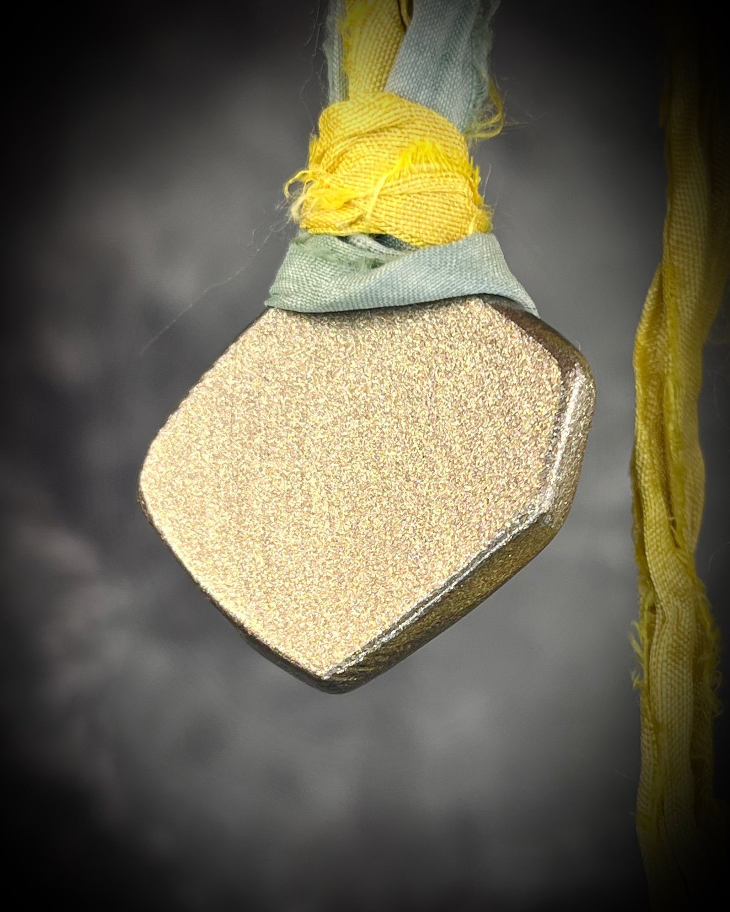 Handmade Libyan Desert Glass pendant necklaces with luminous shifting flashes of green, gold, peach, and rose on sea green and yellow recycled silk by Become Spellbound.