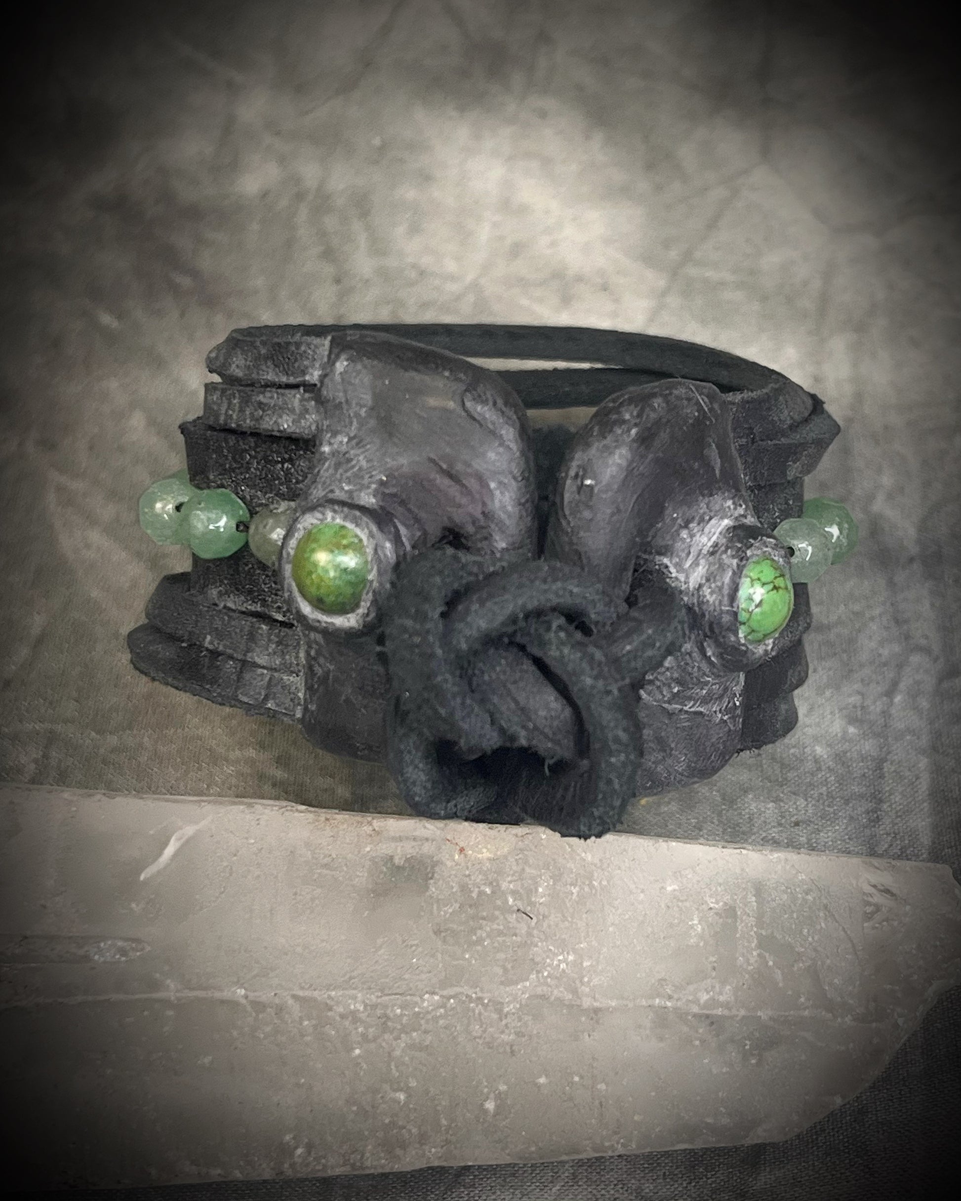 Handmade black leather cuff bracelet with green aventurine beads, chrysocolla accents, layered leather, and adjustable leather tie closure by Anothai Hansen.
