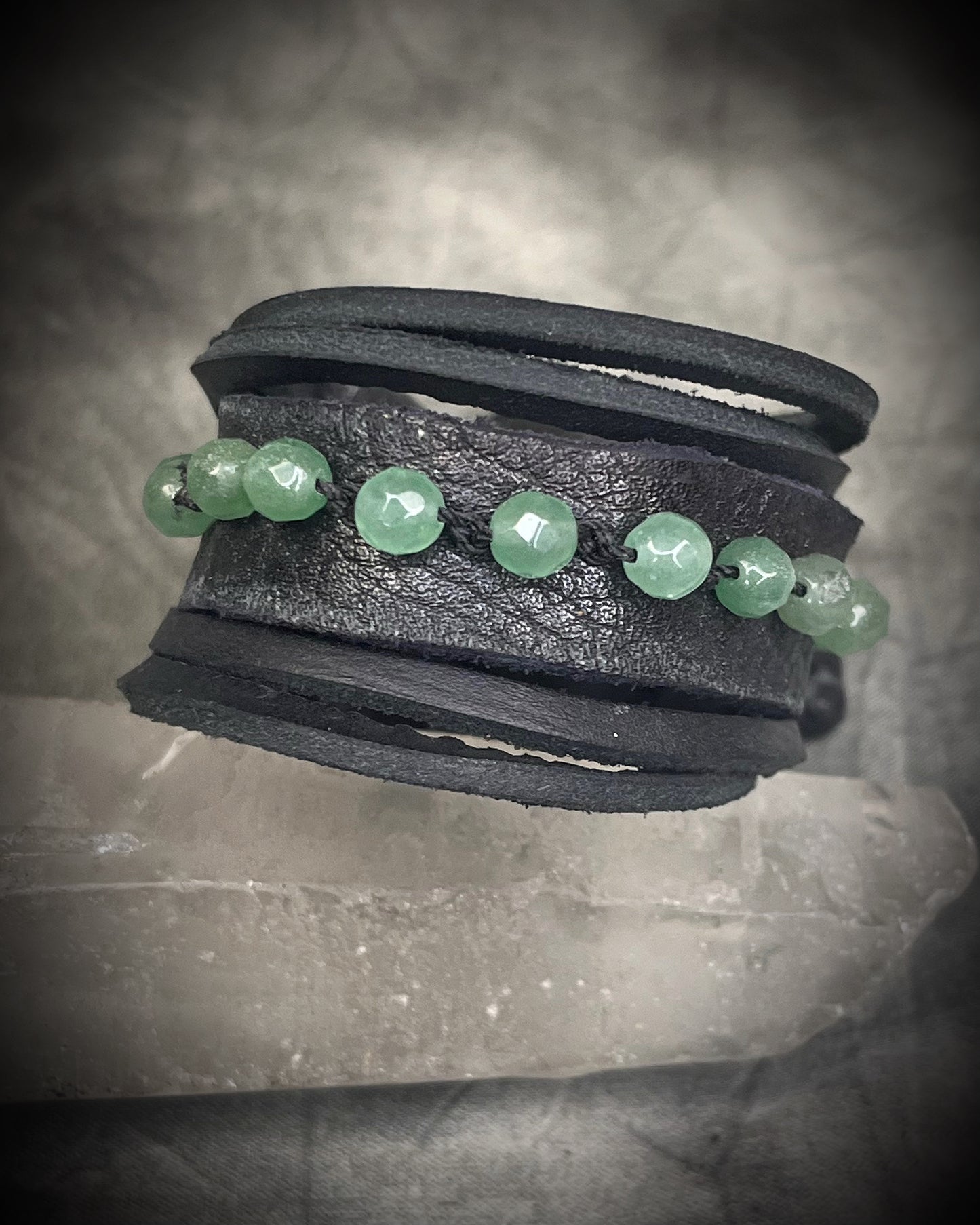 Handmade black leather cuff bracelet with green aventurine beads, chrysocolla accents, layered leather, and adjustable leather tie closure by Anothai Hansen.