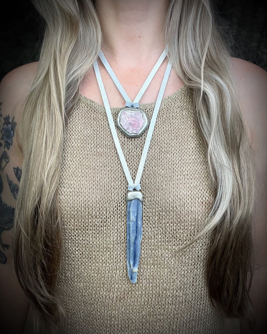 Handmade blue kyanite crystal necklace featuring a natural blue kyanite blade suspended from shimmering silver leather, artisan jewelry by Become Spellbound.