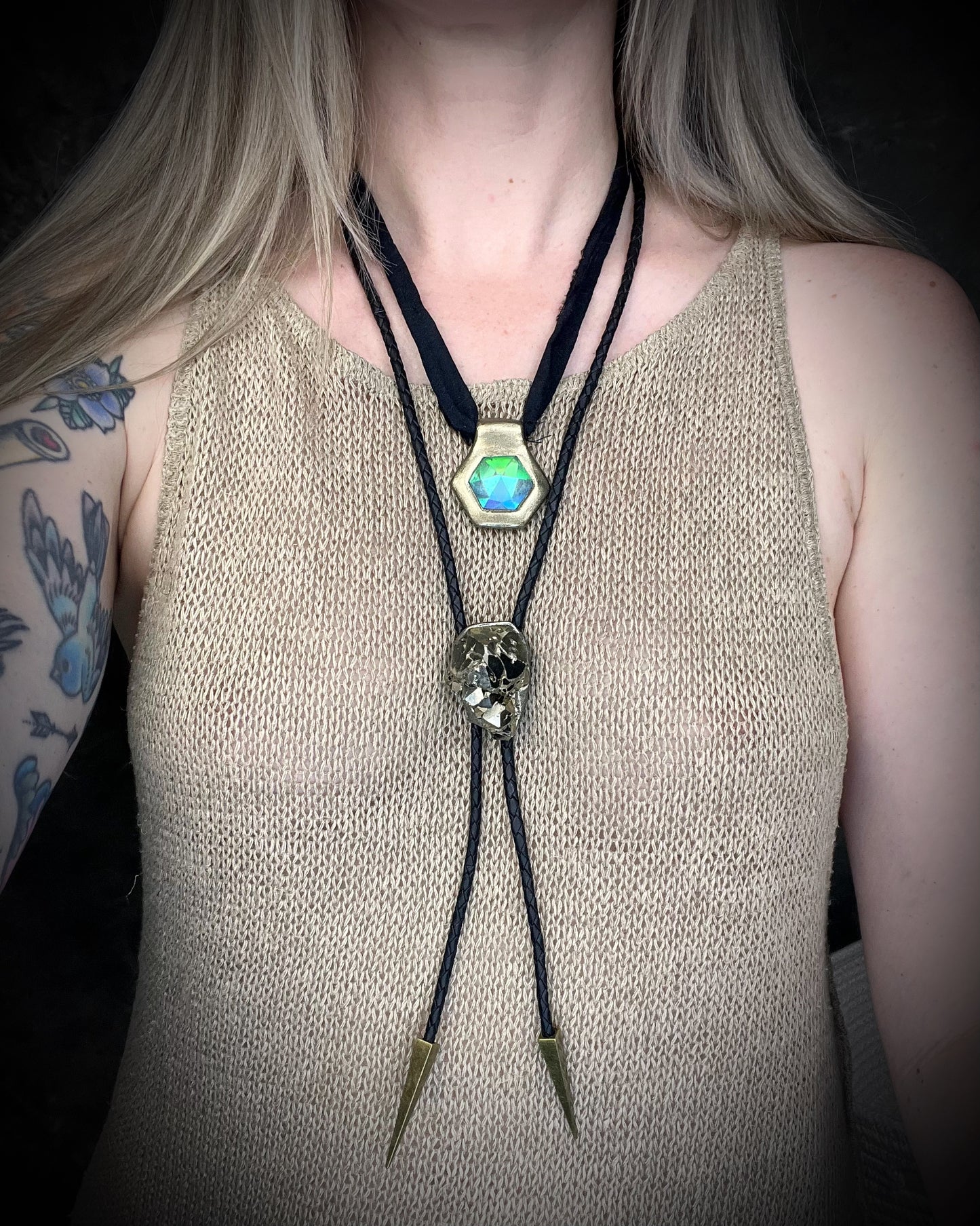 Handmade clear quartz crystal necklace with an aqua flash that feels oceanic and beachy. Framed in gold in a hexagon shape and hung from black recycled silk, this pendant feels like an unearthed treasure. Summer jewelry at its finest! 