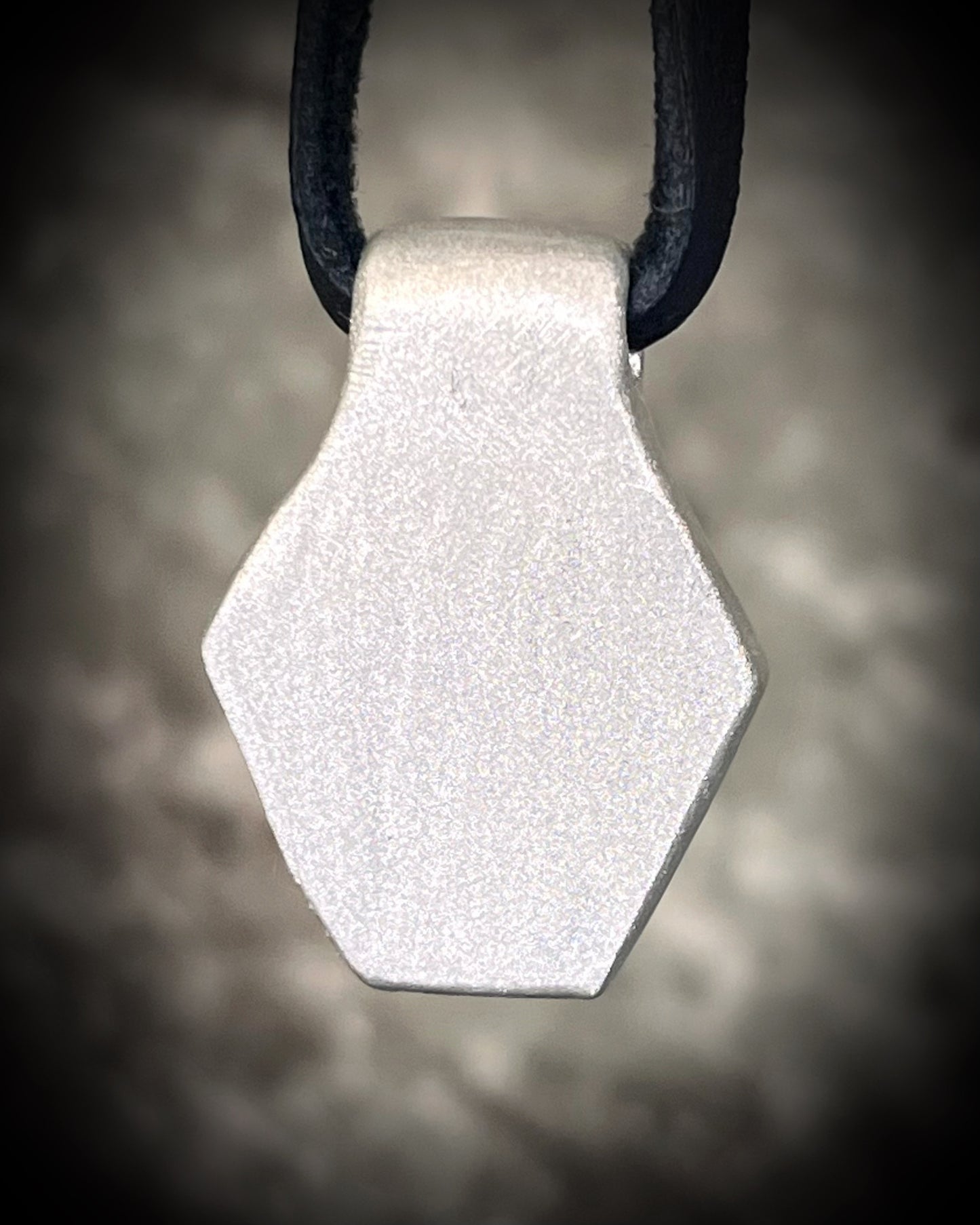 Handmade clear quartz crystal necklace with an opalescent flash that feels enchanted from another realm. Framed in silver in a hexagon shape and hung from black leather, this pendant feels cinematic, and like an unearthed treasure. 