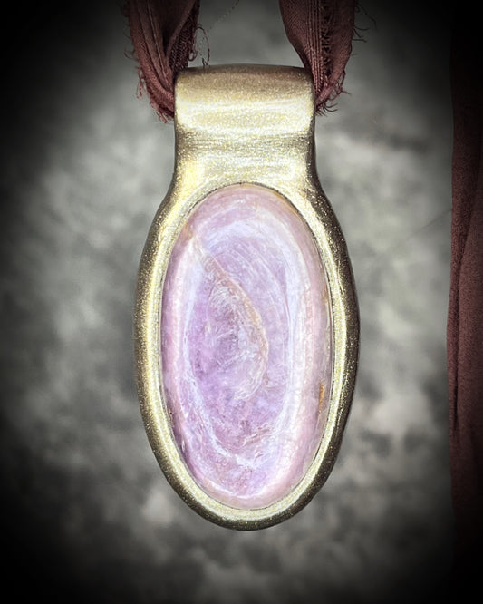 Handmade designer anti-anxiety crystal lepidolite raw stone necklace in gold finish.  This gemstone pendant is hung from earthy brown recycled silk for a raw and sustainable elegance. 