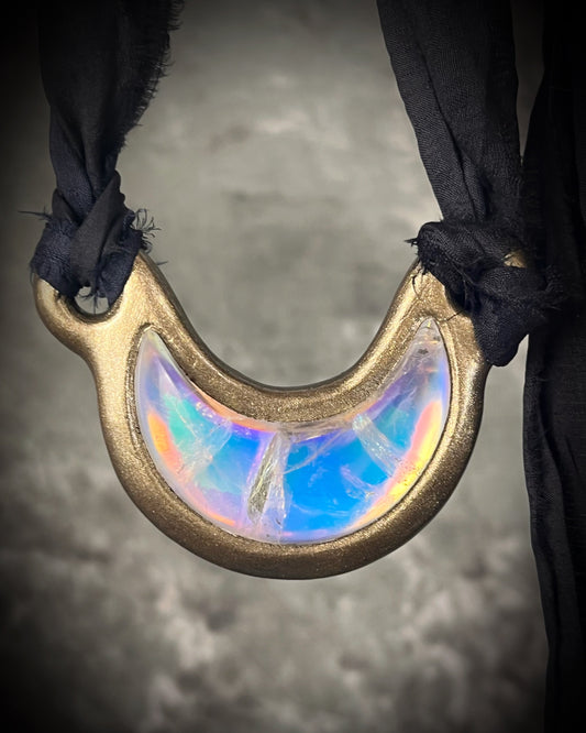 Handmade designer opalescent quartz gemstone crescent moon pendant in a gold finish.  This crystal healing necklace is strung from black recycled silk for the eco-friendly jewelry collector. 