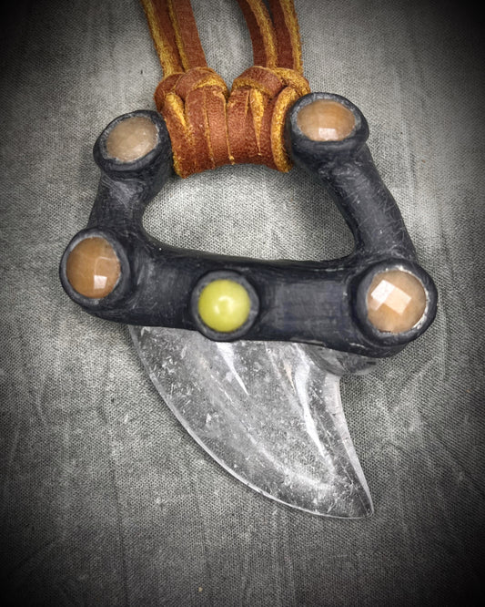 Handmade leather and gemstone pendant by Anothai Hansen featuring a shark tooth shaped quartz crystal accented with warm honey jade and vibrant yellow jade.
