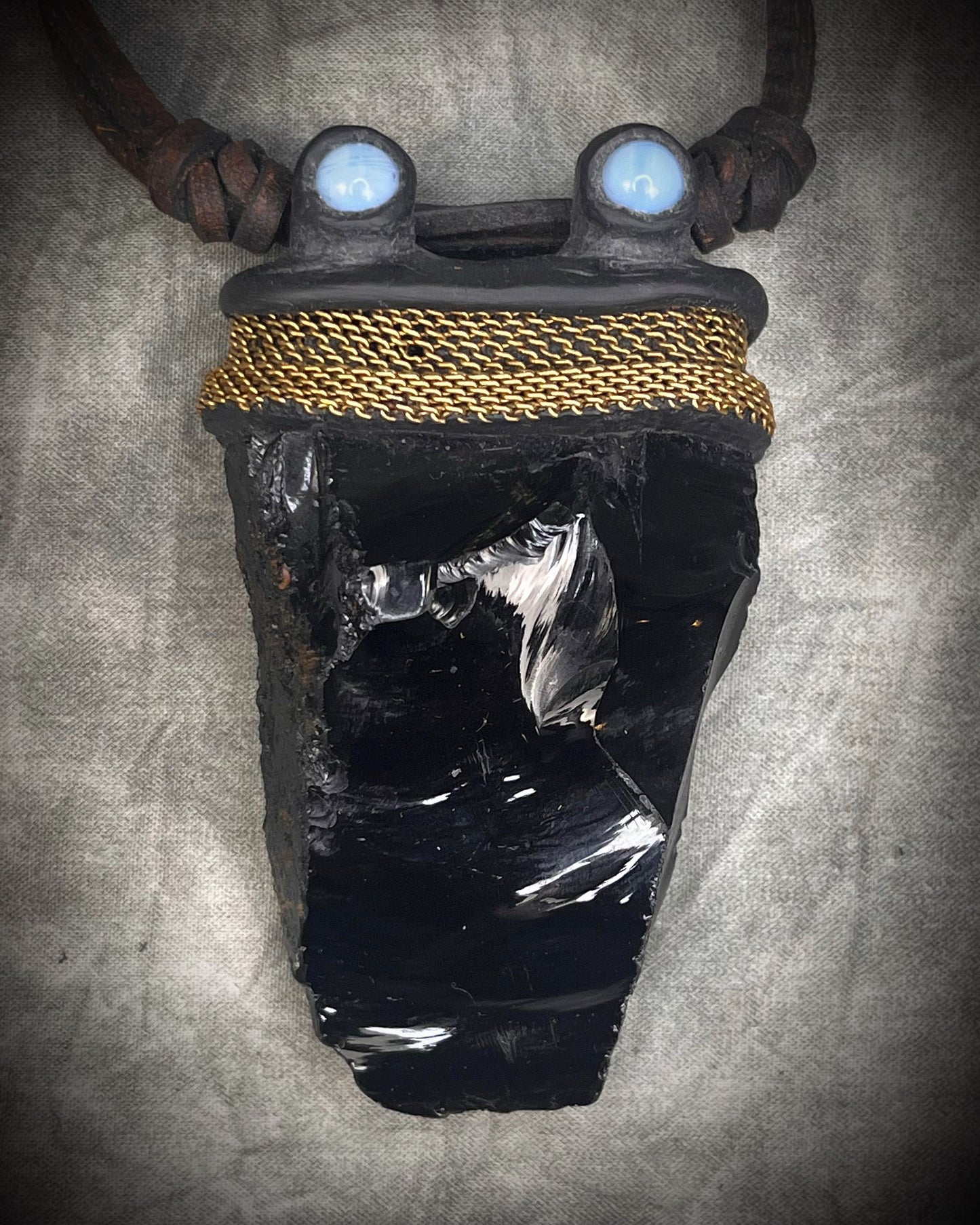 Handmade leather crystal necklace with raw obsidian, opalite crystals, metal chain detail, and handmade wire clasp by Anothai Hansen.
