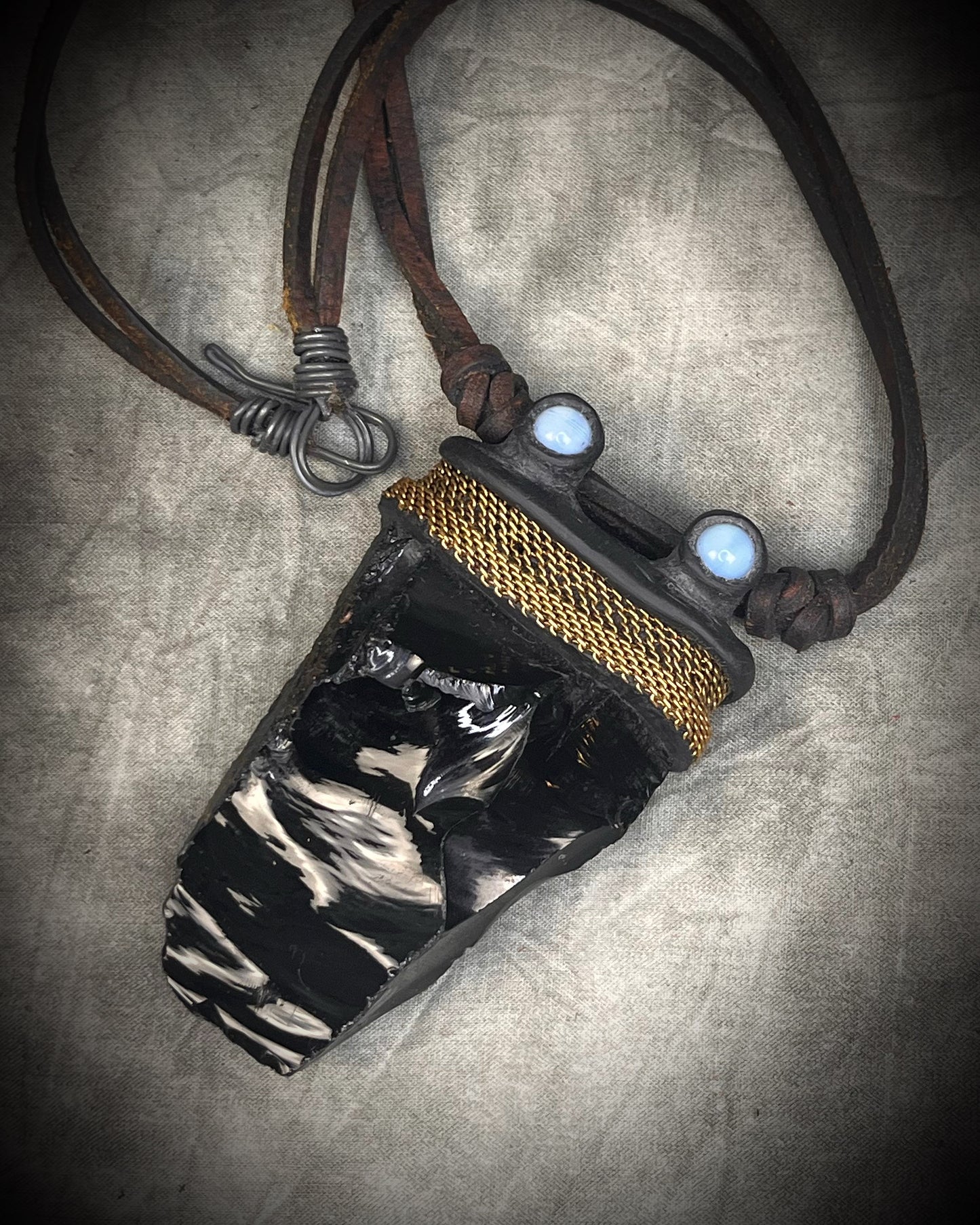 Handmade leather crystal necklace with raw obsidian, opalite crystals, metal chain detail, and handmade wire clasp by Anothai Hansen.