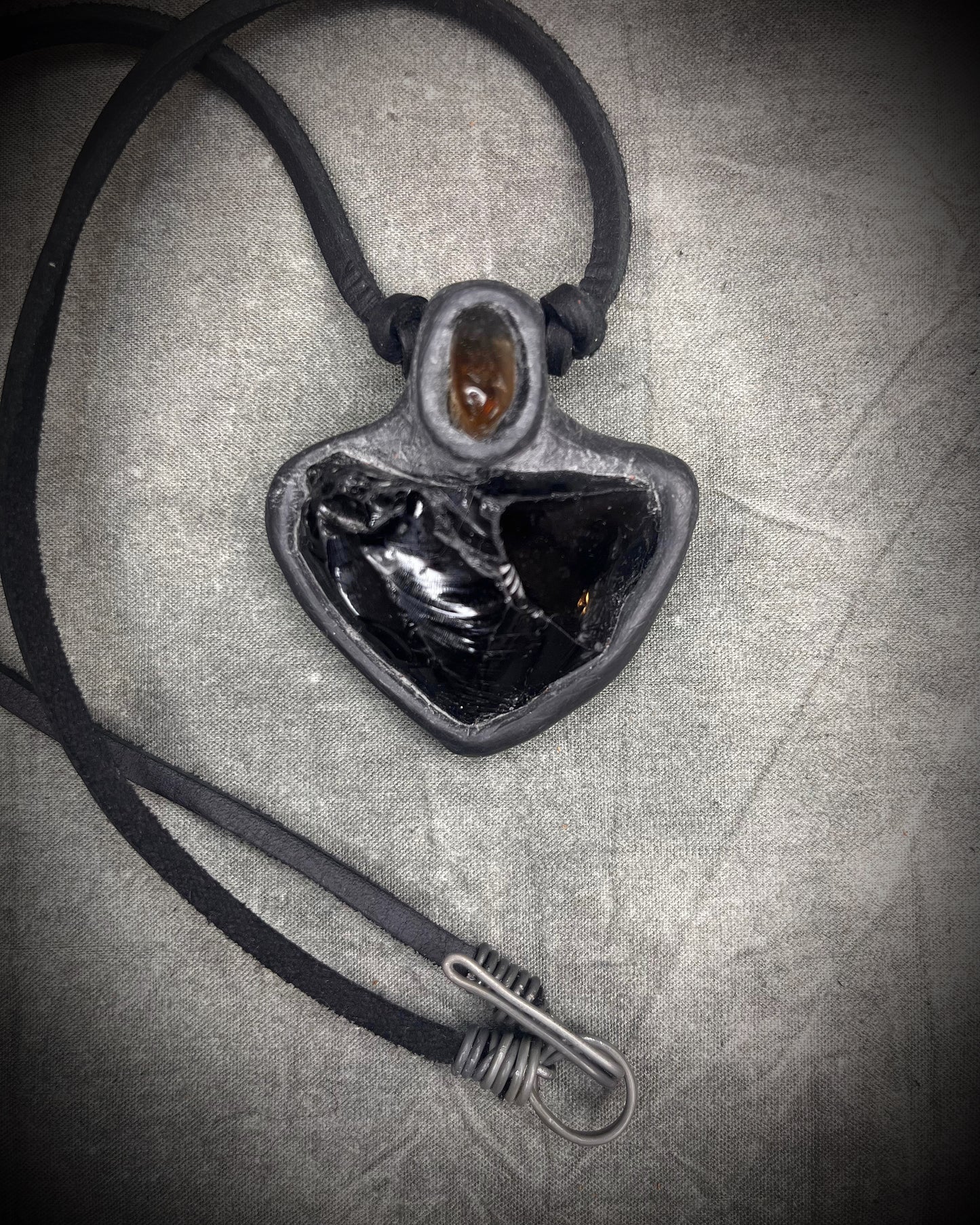 Handmade obsidian pendant with citrine crystal on black leather featuring a handmade wire clasp, rugged artisan gemstone necklace by Anothai Hansen.