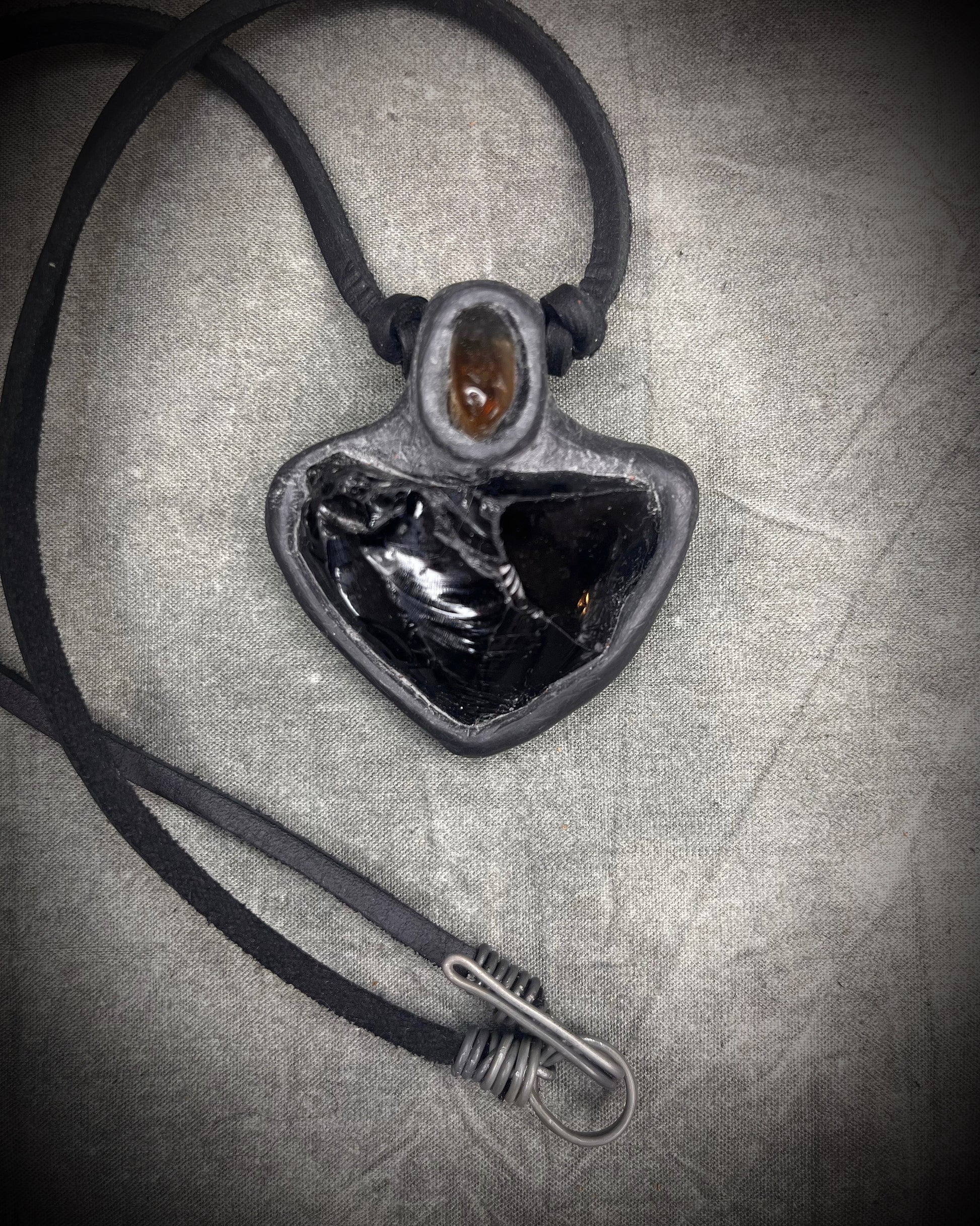 Handmade obsidian pendant with citrine crystal on black leather featuring a handmade wire clasp, rugged artisan gemstone necklace by Anothai Hansen.