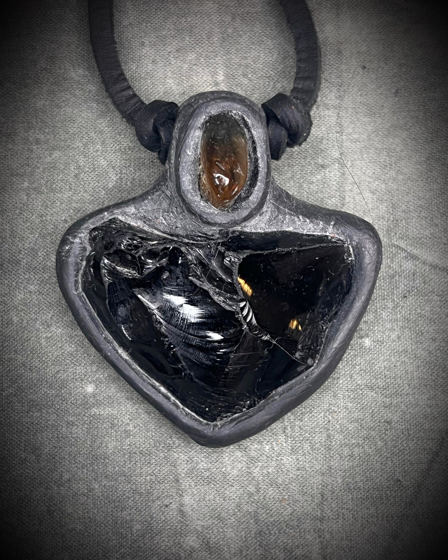 Handmade obsidian pendant with citrine crystal on black leather featuring a handmade wire clasp, rugged artisan gemstone necklace by Anothai Hansen.