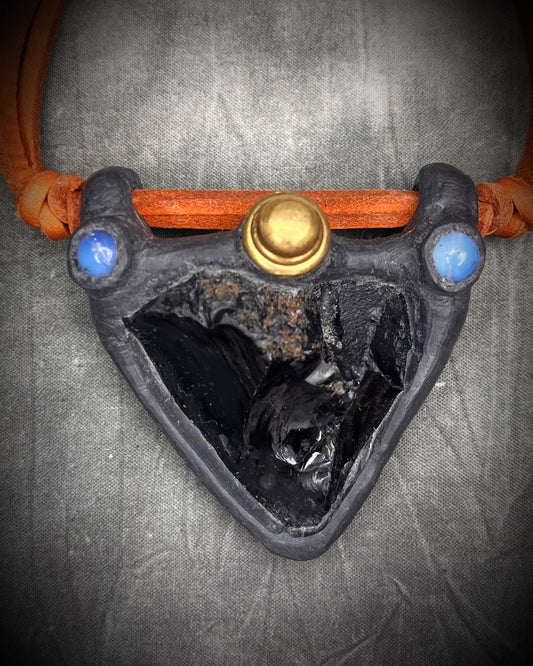 Handmade obsidian pendant with opalite crystals and brass details on orange leather featuring a handmade wire clasp by Anothai Hansen.