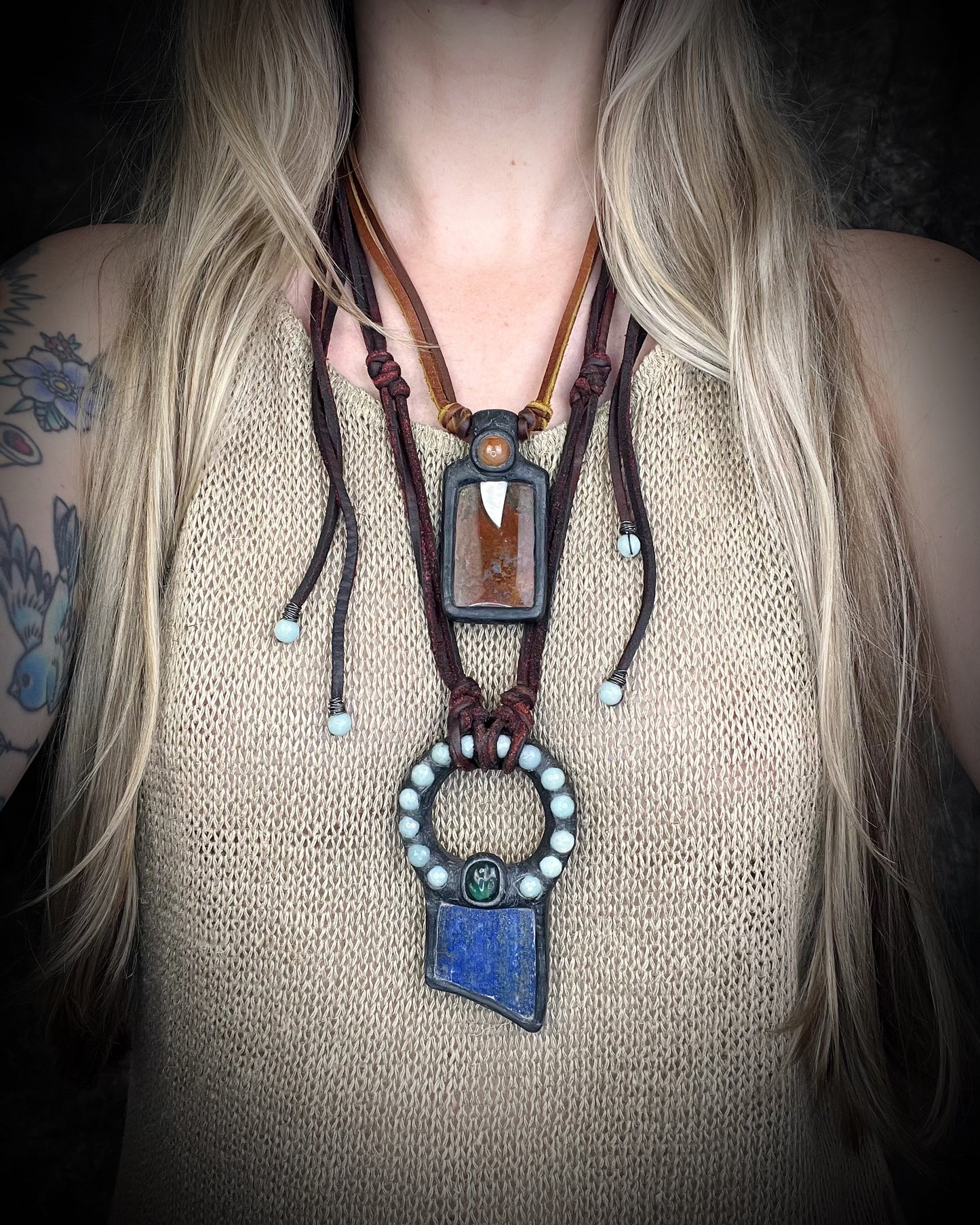 Handmade red agate pendant with carnelian and abalone shell on brown leather featuring a handmade copper-colored wire clasp by Anothai Hansen. worn here layered with lapis pendant. 