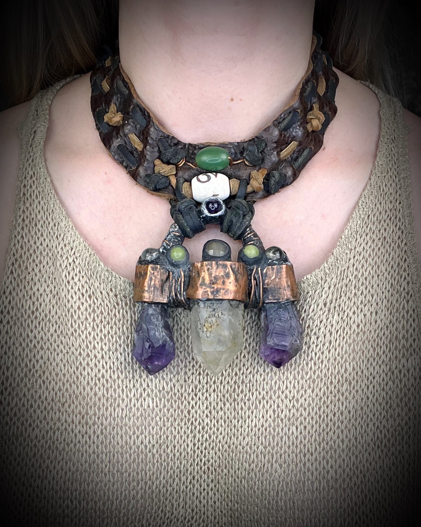 Handmade trident leather choker with quartz point, amethyst points, yellow jade, brass details, and copper wire clasp by Anothai Hansen.