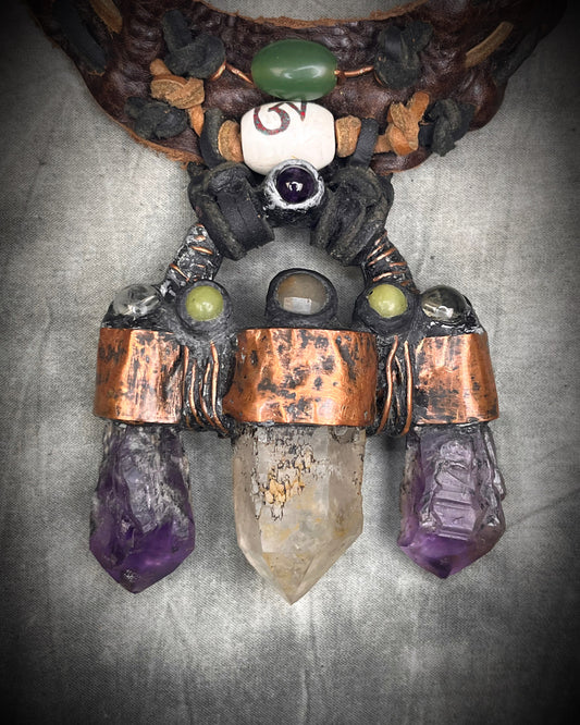 Handmade trident leather choker with quartz point, amethyst points, yellow jade, brass details, and copper wire clasp by Anothai Hansen.
