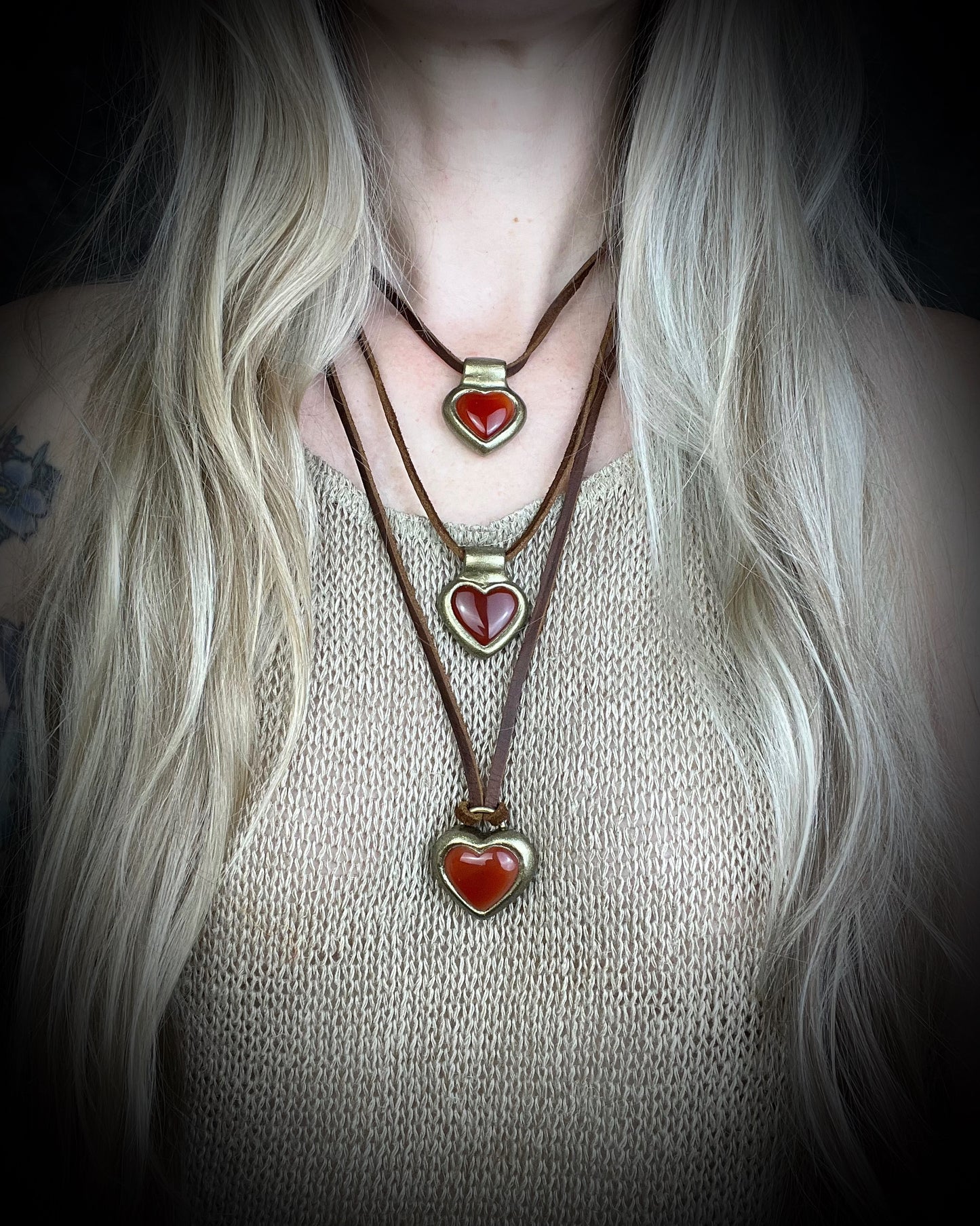 Heart-shaped pendants with red hearts in a gold finish on brown leather. Holiday gift for her!