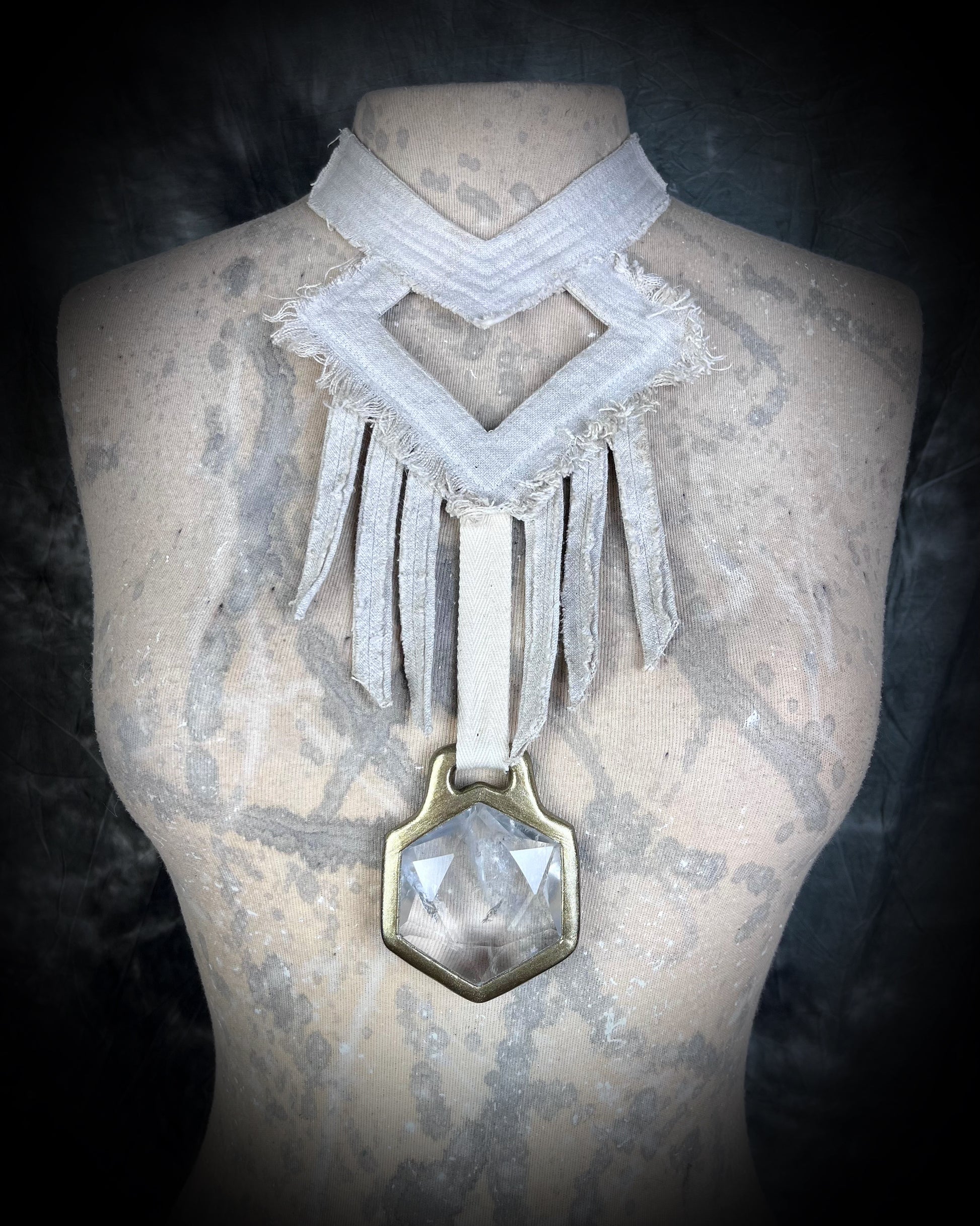 A stunning handmade raw linen collar statement style necklace featuring a handcrafted quartz star of david hexagon crystal and geometric shapes and fringe.  Wearable art for a boho free spirit or festival jewelry!