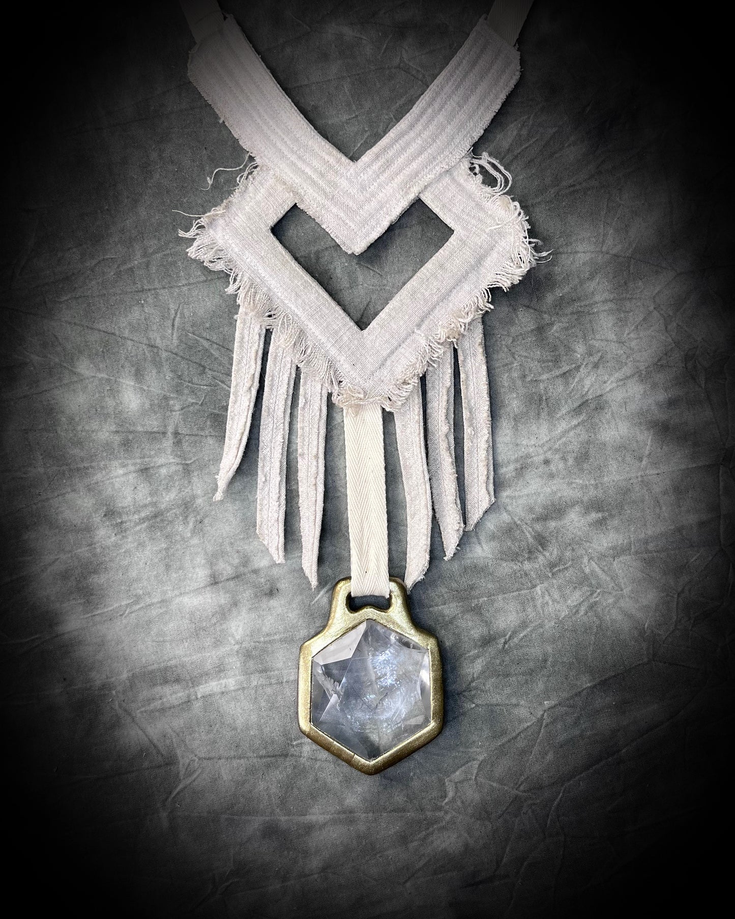 A stunning handmade raw linen collar statement style necklace featuring a handcrafted quartz star of david hexagon crystal and geometric shapes and fringe.  Wearable art for a boho free spirit or festival jewelry!