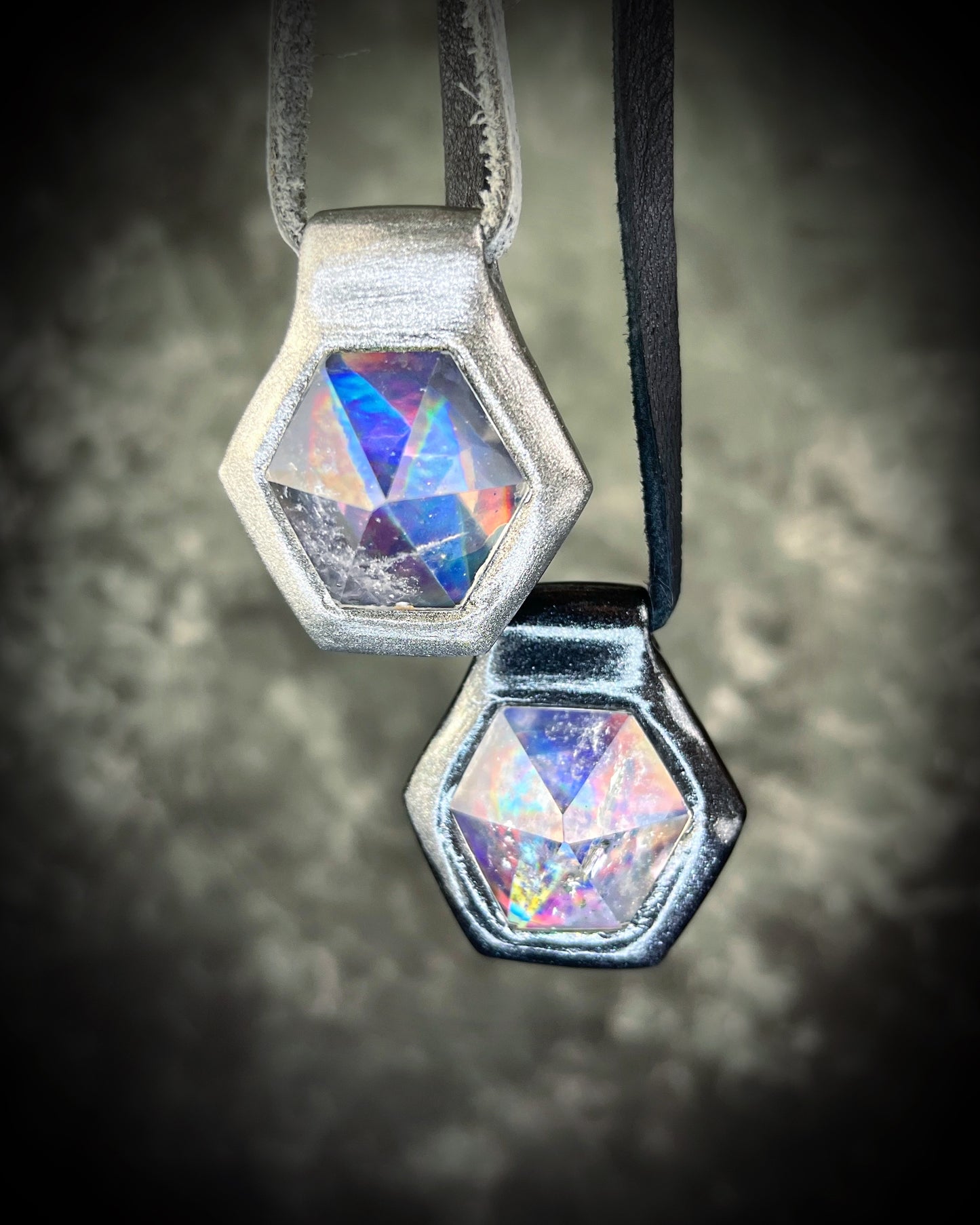 Silver and Black David Bowie inspired handmade designer quartz crystal black rainbow pendants. Black finish on black leather and gunmetal finish on silver leather. 