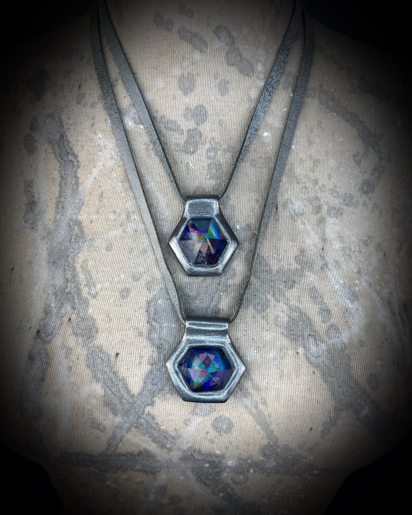 Closeup stacked gunmetal silver David Bowie inspired designer quartz rainbow necklaces, matching silver leather customizable from choker to pendant. 